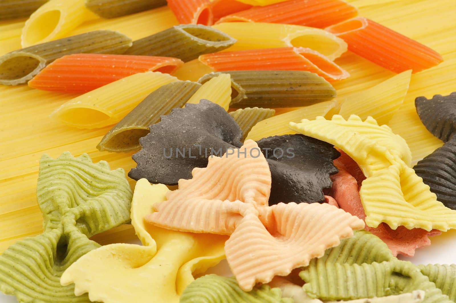 Italian pasta spaghetti, Penne rigate tricolore and farfalle as background