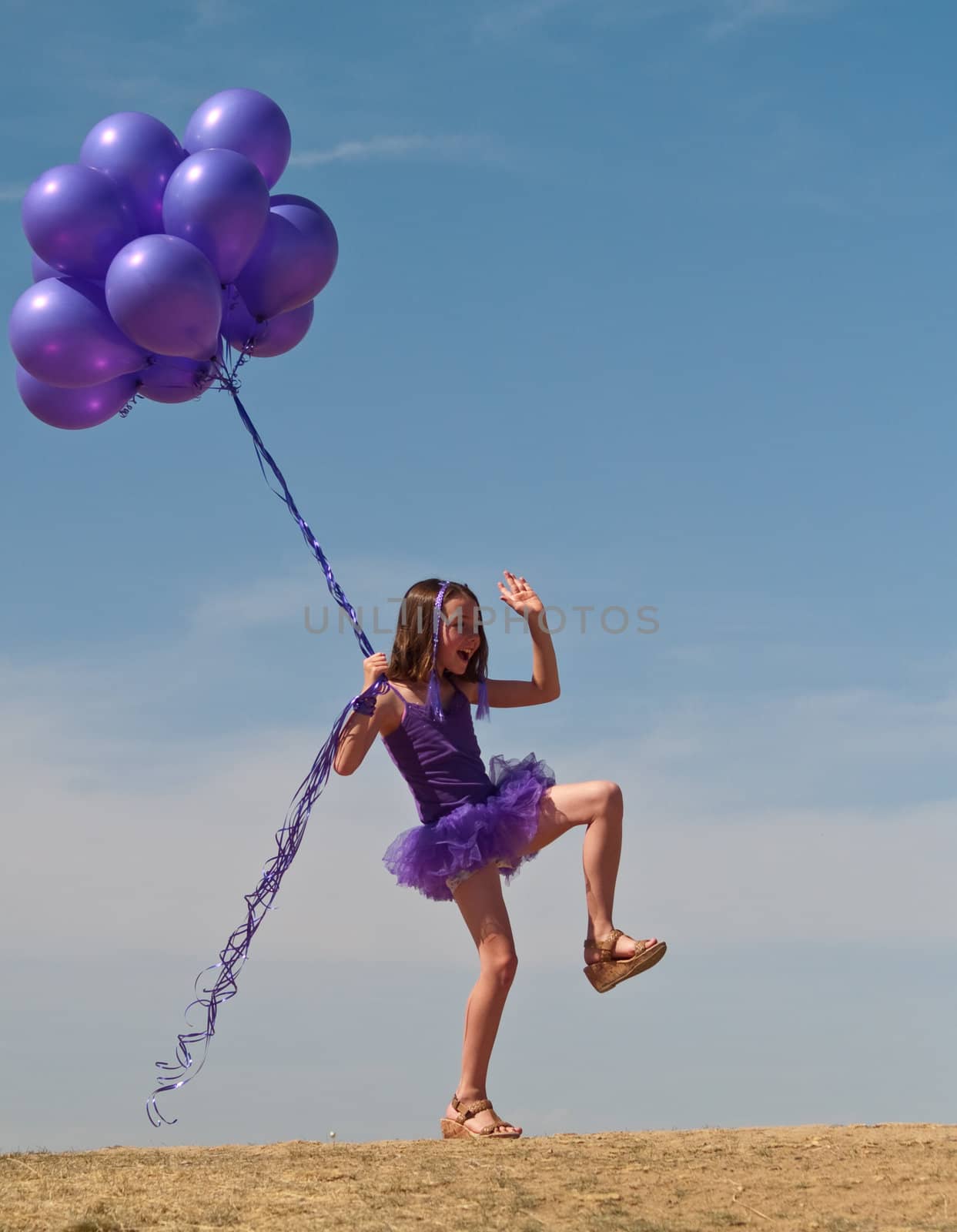 Pretty little girl with baloons in hand