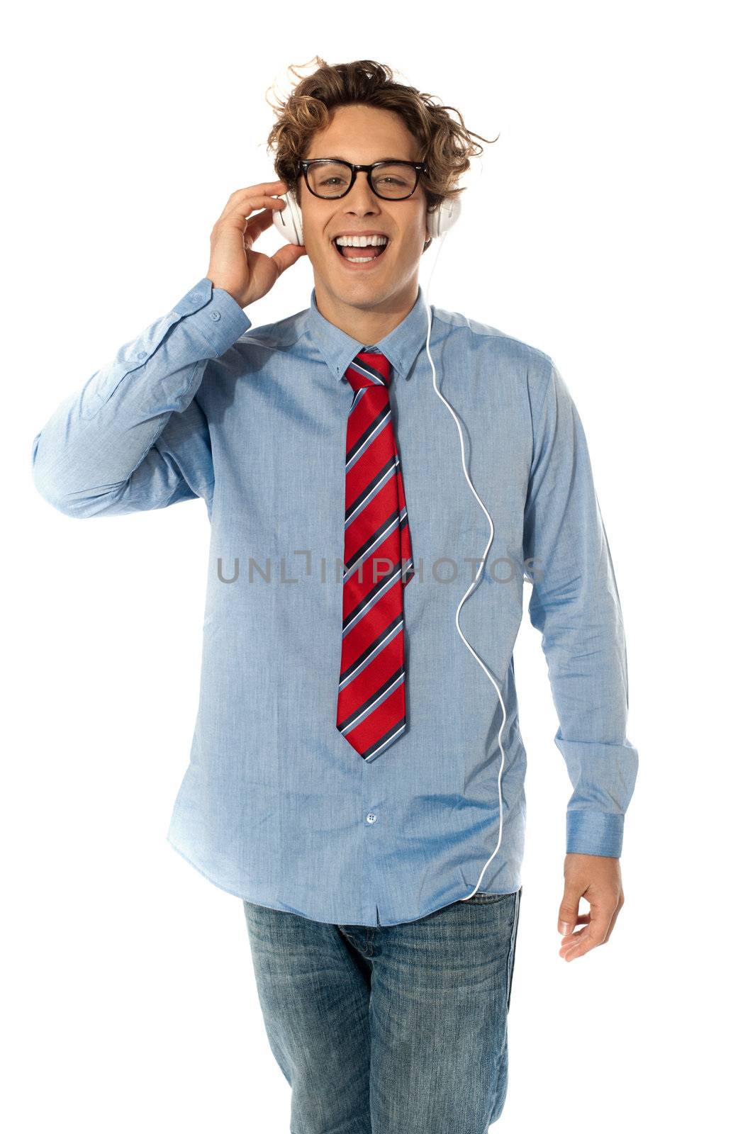 Young man listening to music isolated