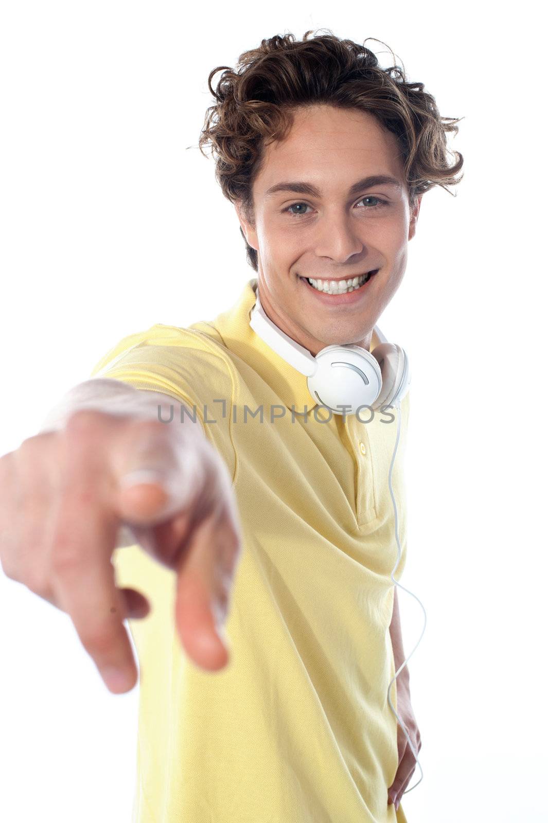 Guy with headphones enjoying music, pointing at you