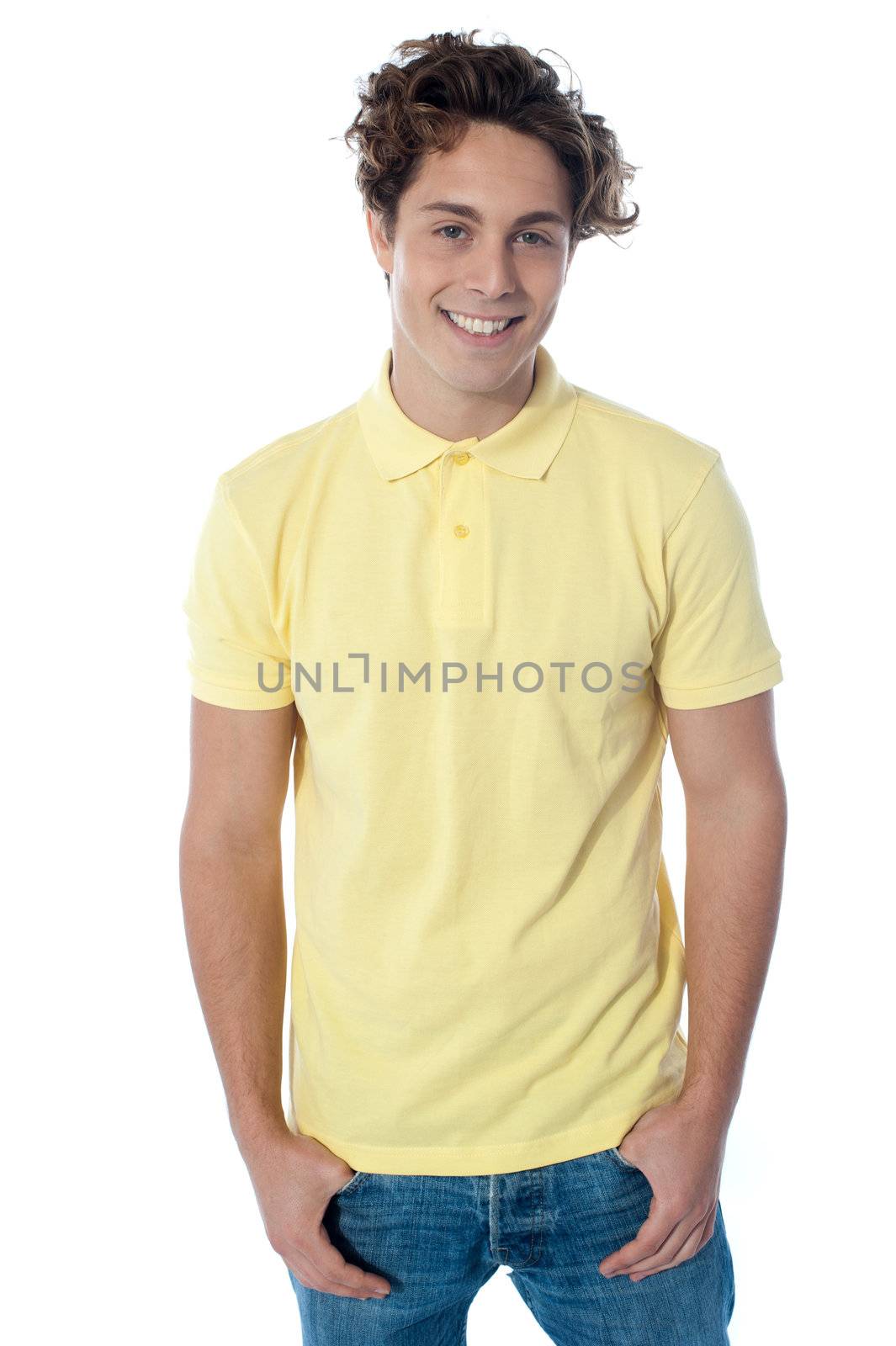 Portrait of a stylish young man standing with hands in pockets over white background