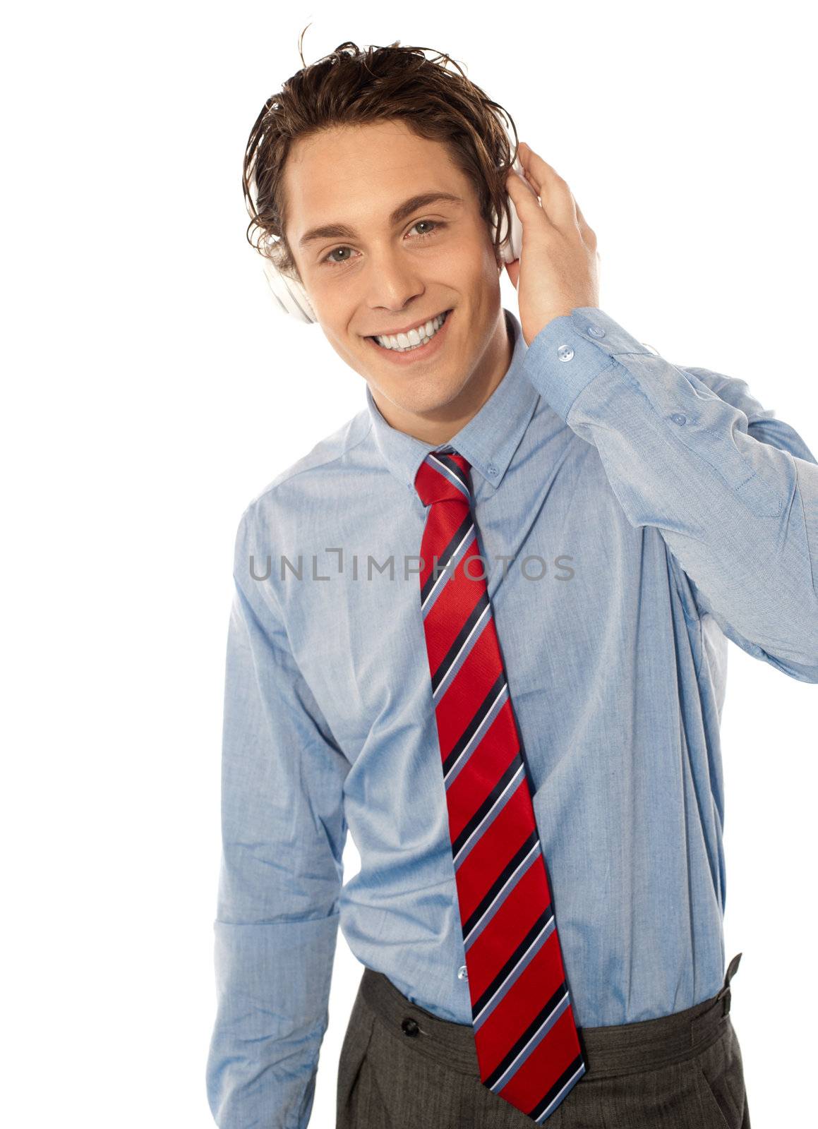 Relaxed young smiling male listening to music isolated on white