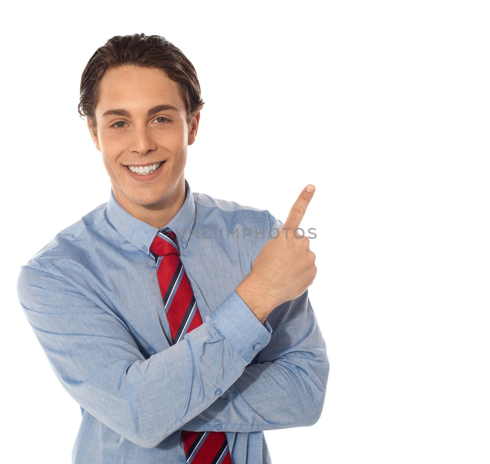 Business male pointing upwards and smiling at camera