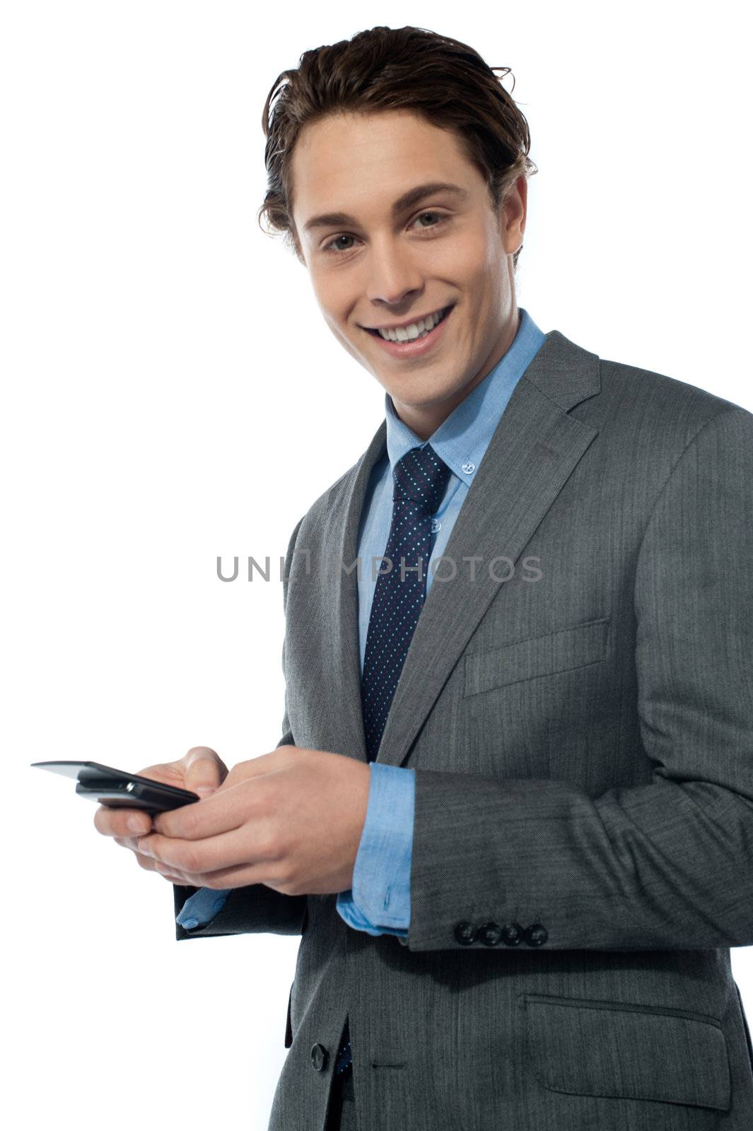 Handsome young man navigating on his smartphone by stockyimages