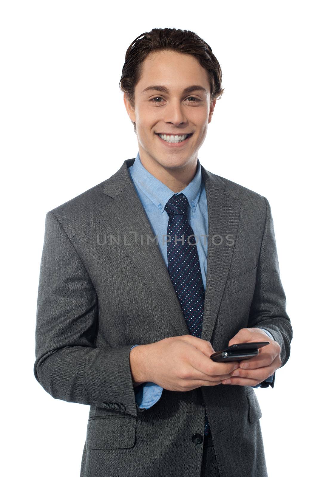 Handsome businessman using a smartphone by stockyimages