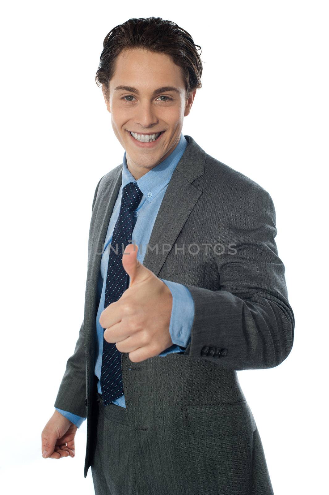 Corporate man showing thumbs up sign with smile