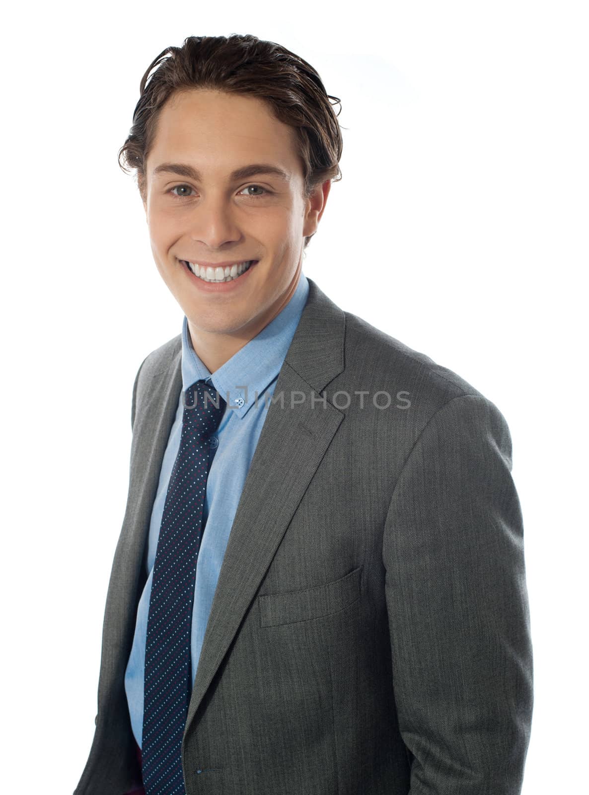 Smiling young businessman looking at you isolated on white