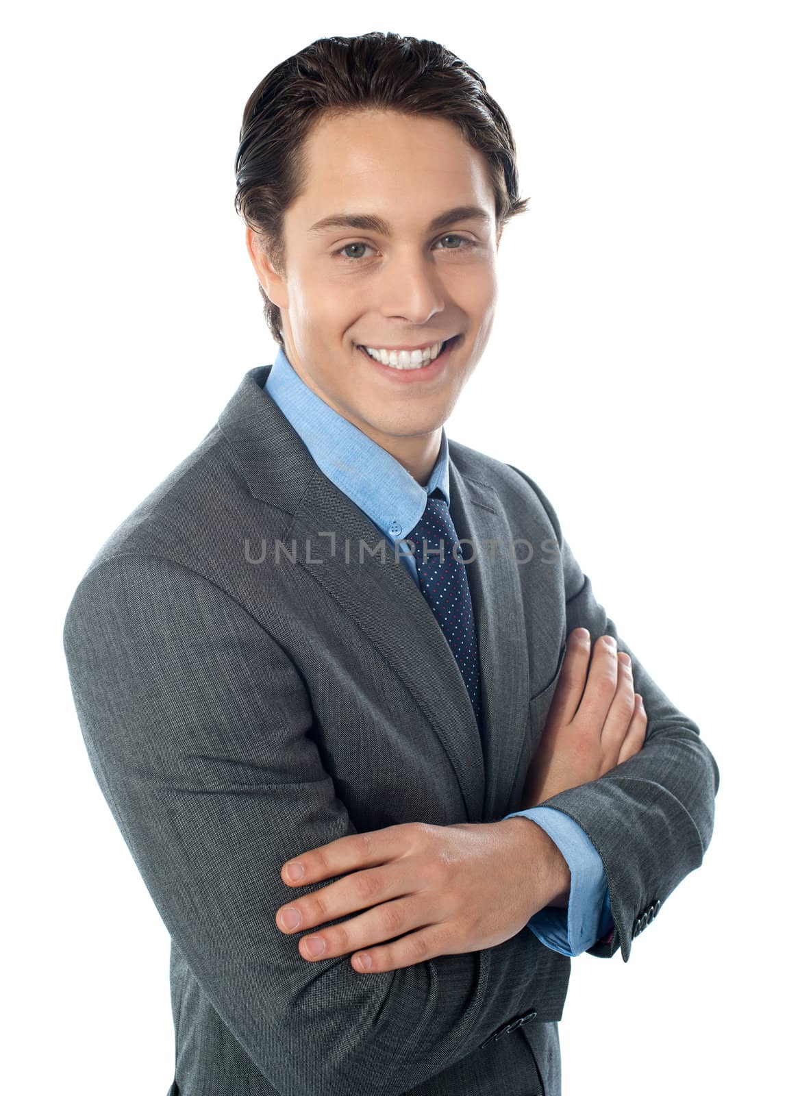 Charming young businessman posing in style by stockyimages