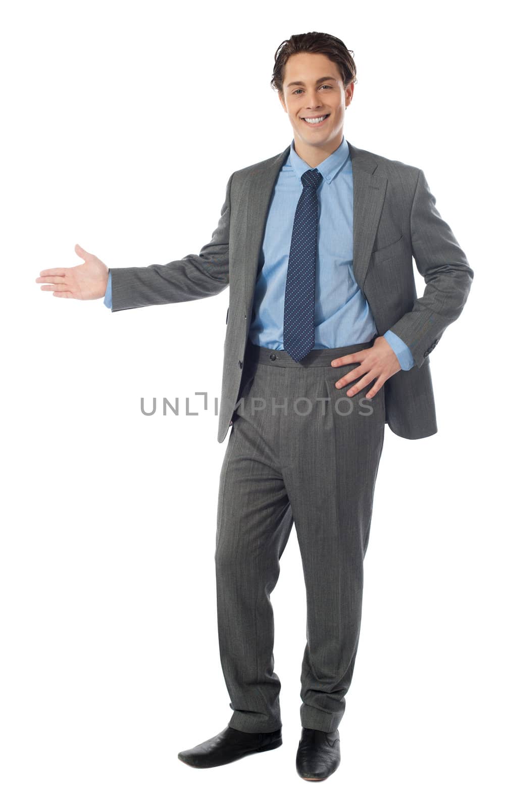 Full length of successful businessman presenting over white background