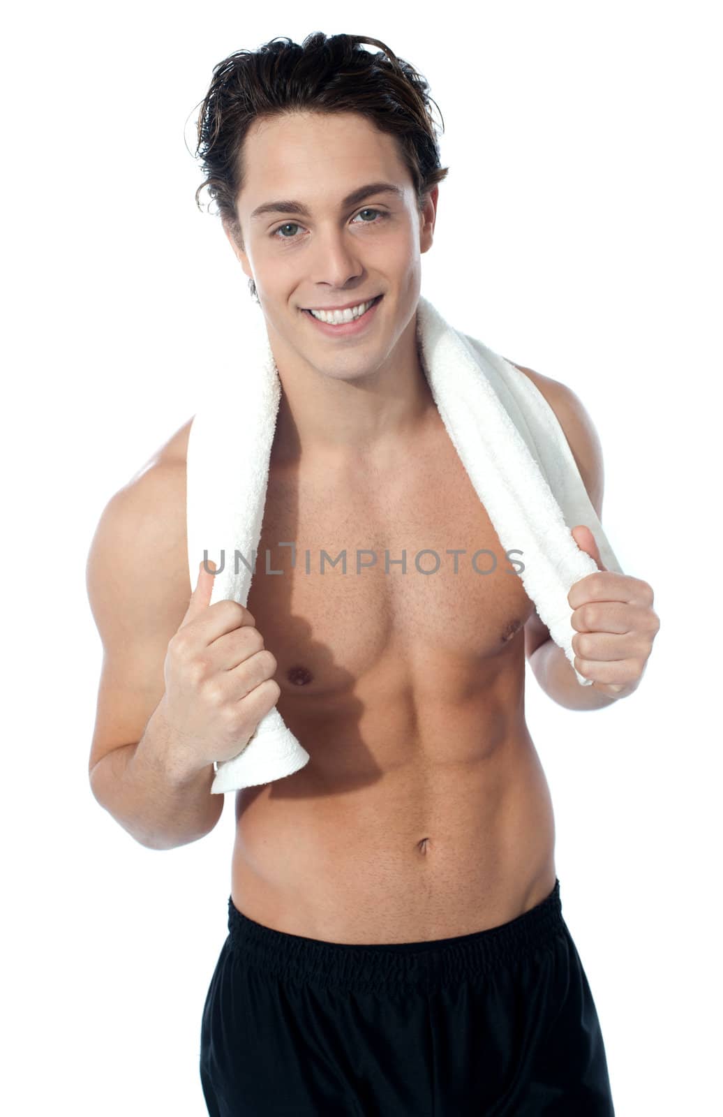 Handsome muscular man with the towel after completing his workout