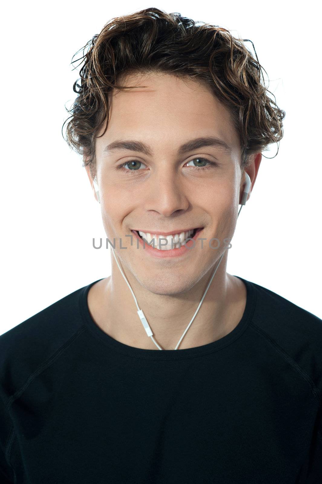 Young handsome guy listening music, closeup portrait