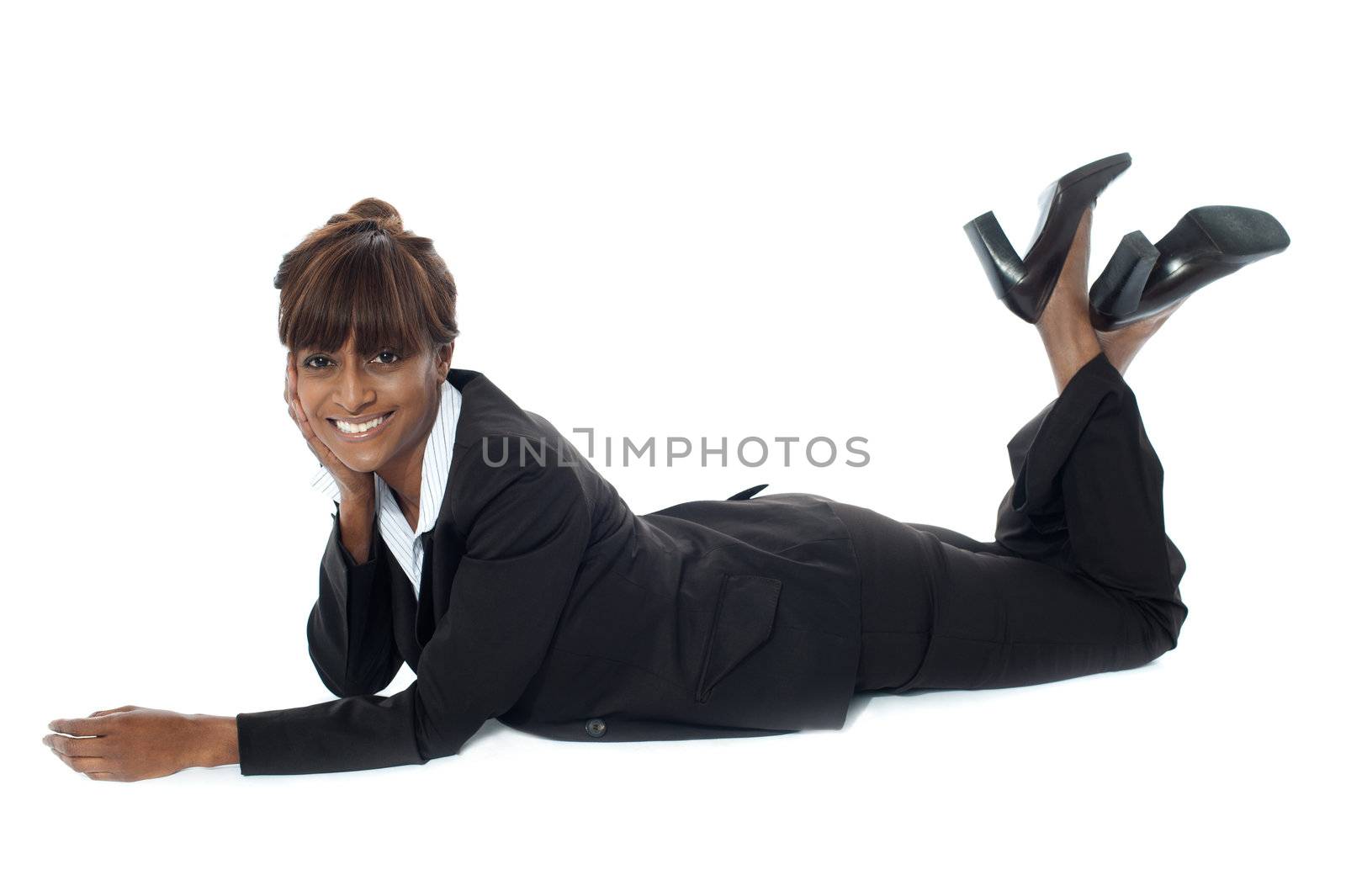 Corporate woman lying on floor, smiling by stockyimages