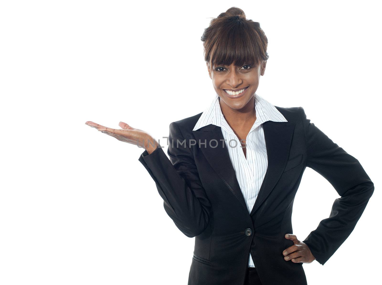 Female executive exposing copyspace area, smiling at camera