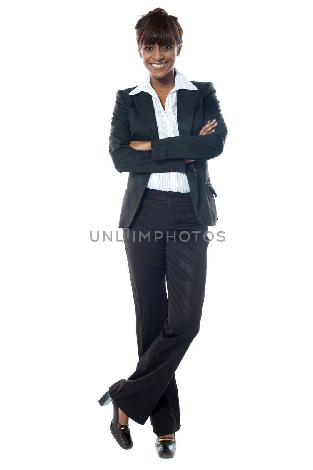 Young beautiful businesslady posing with legs crossed against white background