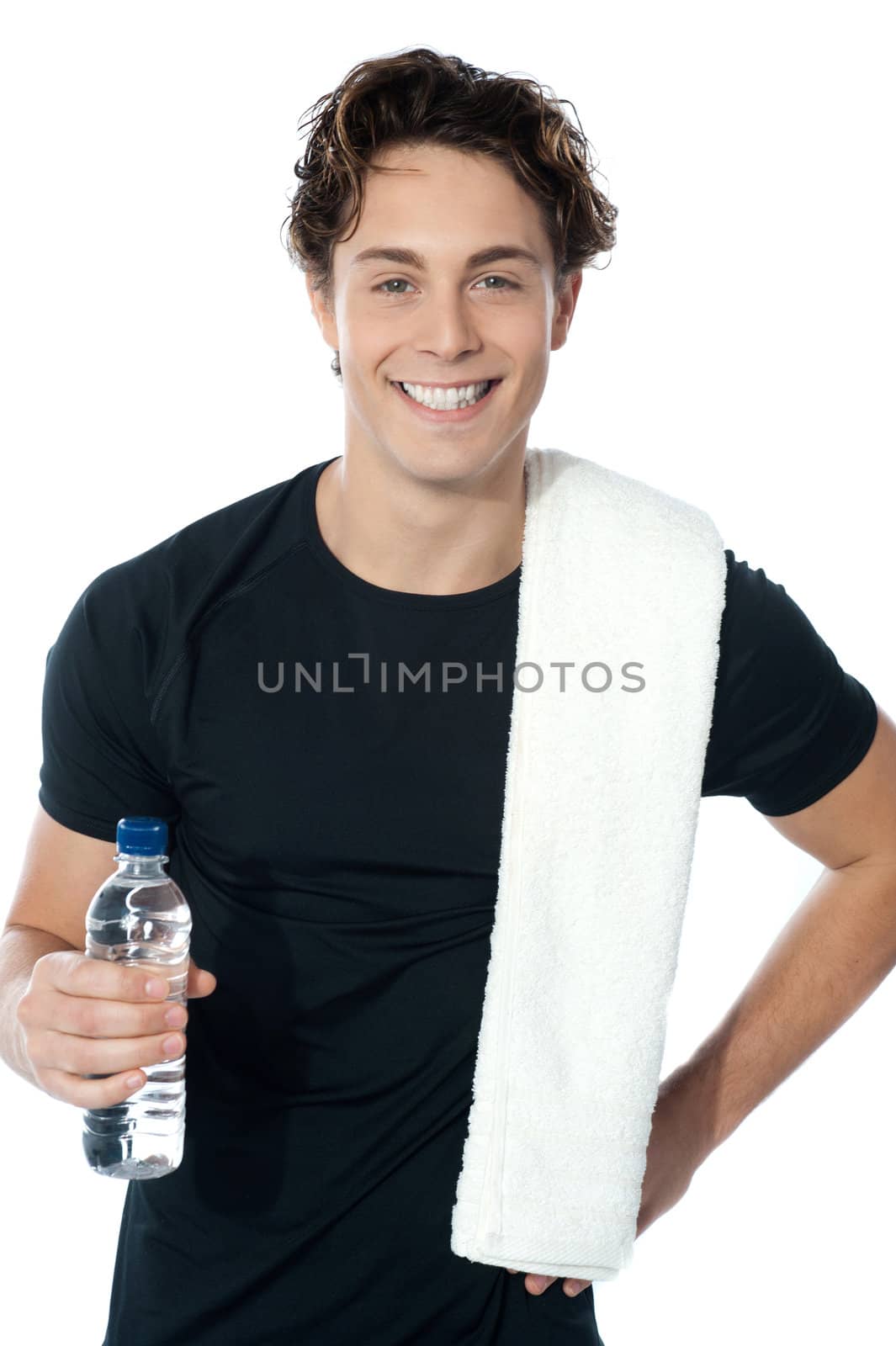 Handsome muscular man with towel holding a bottle of water