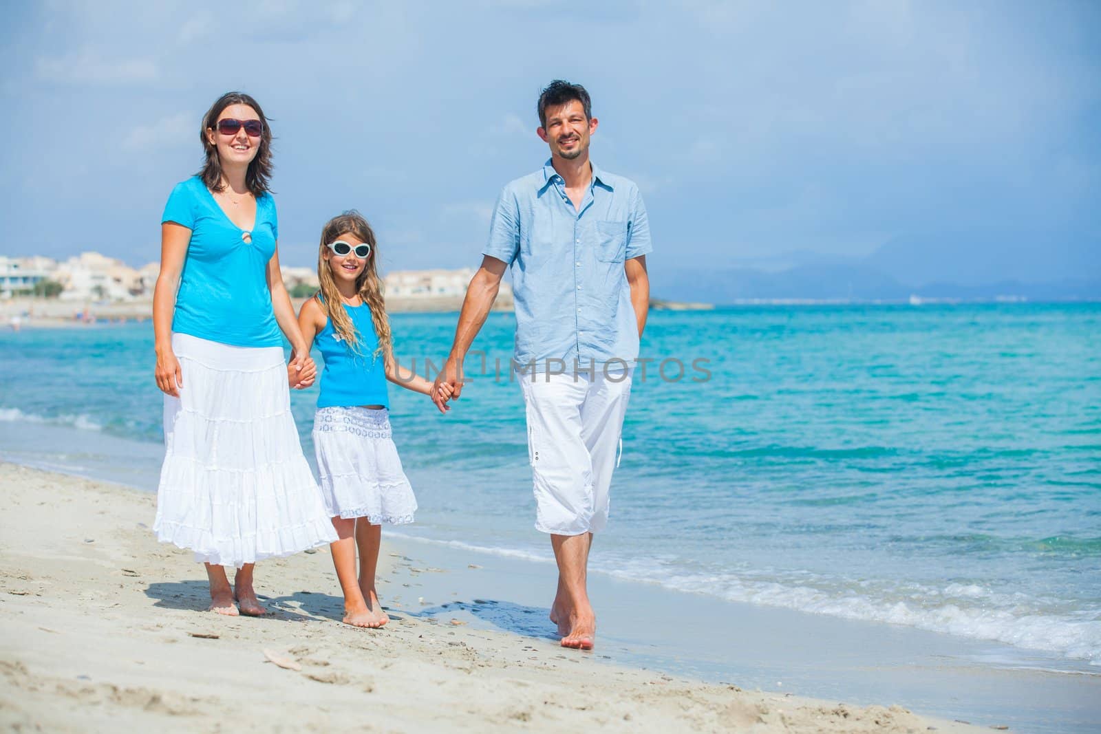 Family having fun on tropical beach by maxoliki