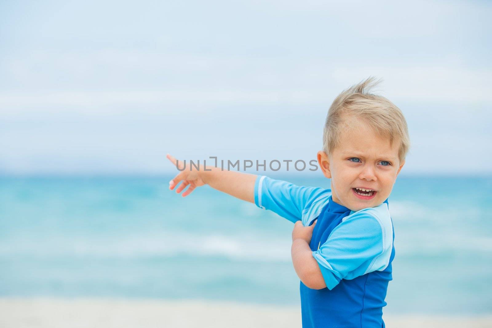 Back view cute 2 years old boy runing on tropical beach