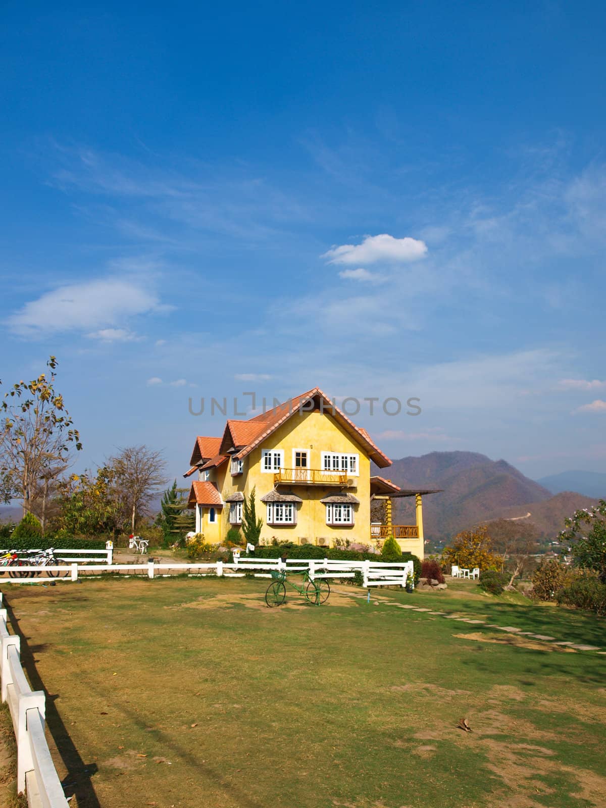 Yellow lovely house and blue sky in pai, mae hong son, thailand by gururugu