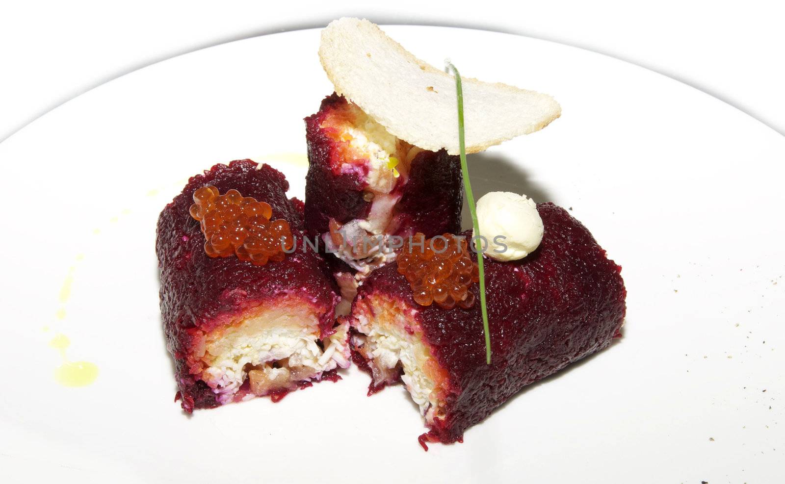 rolls with caviar, beets and herring on a white plate