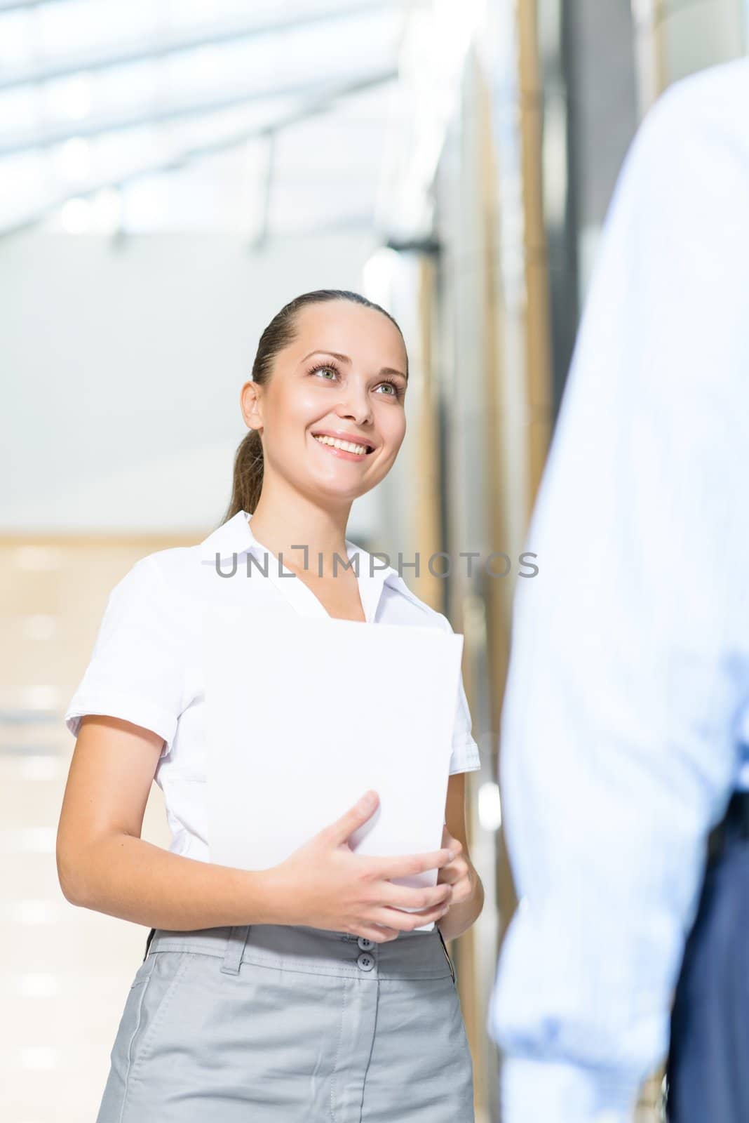 Business woman talking with a colleague in the office