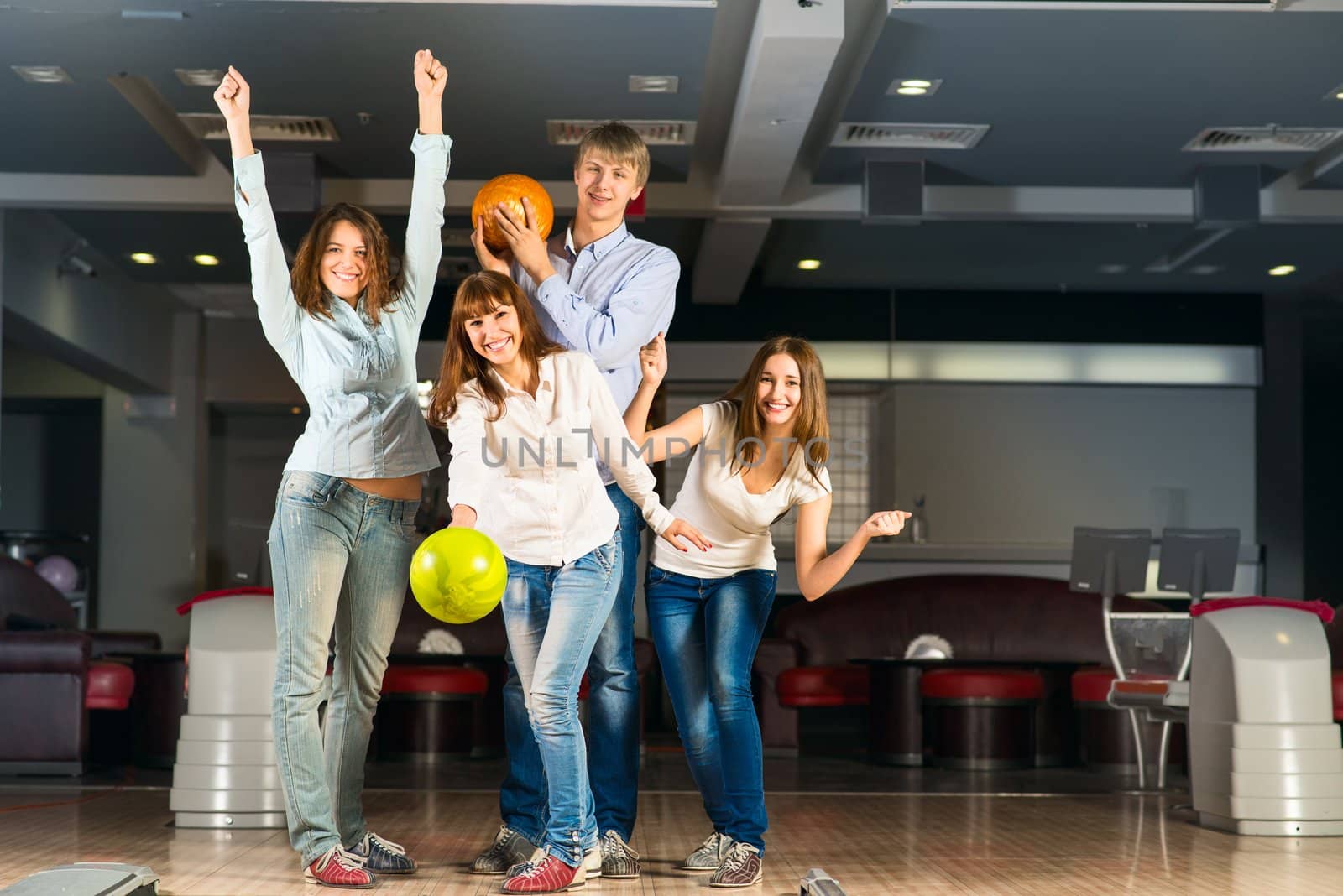 Group of young friends playing bowling by adam121