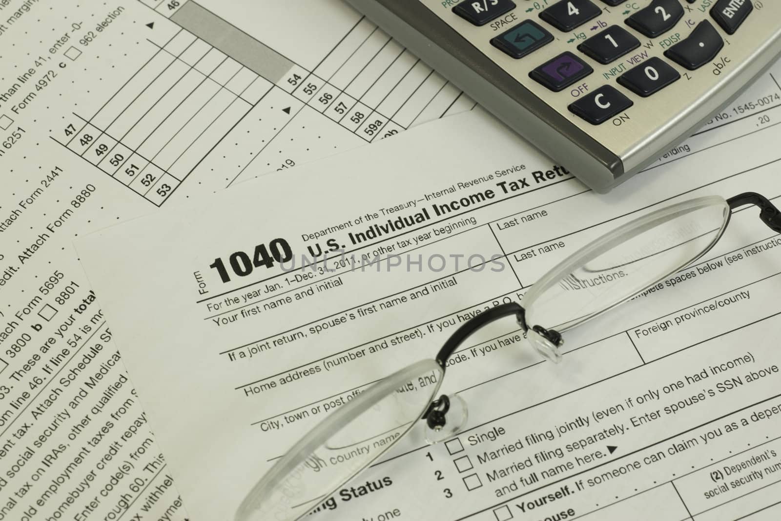 tax form with a calculator and reading glasses