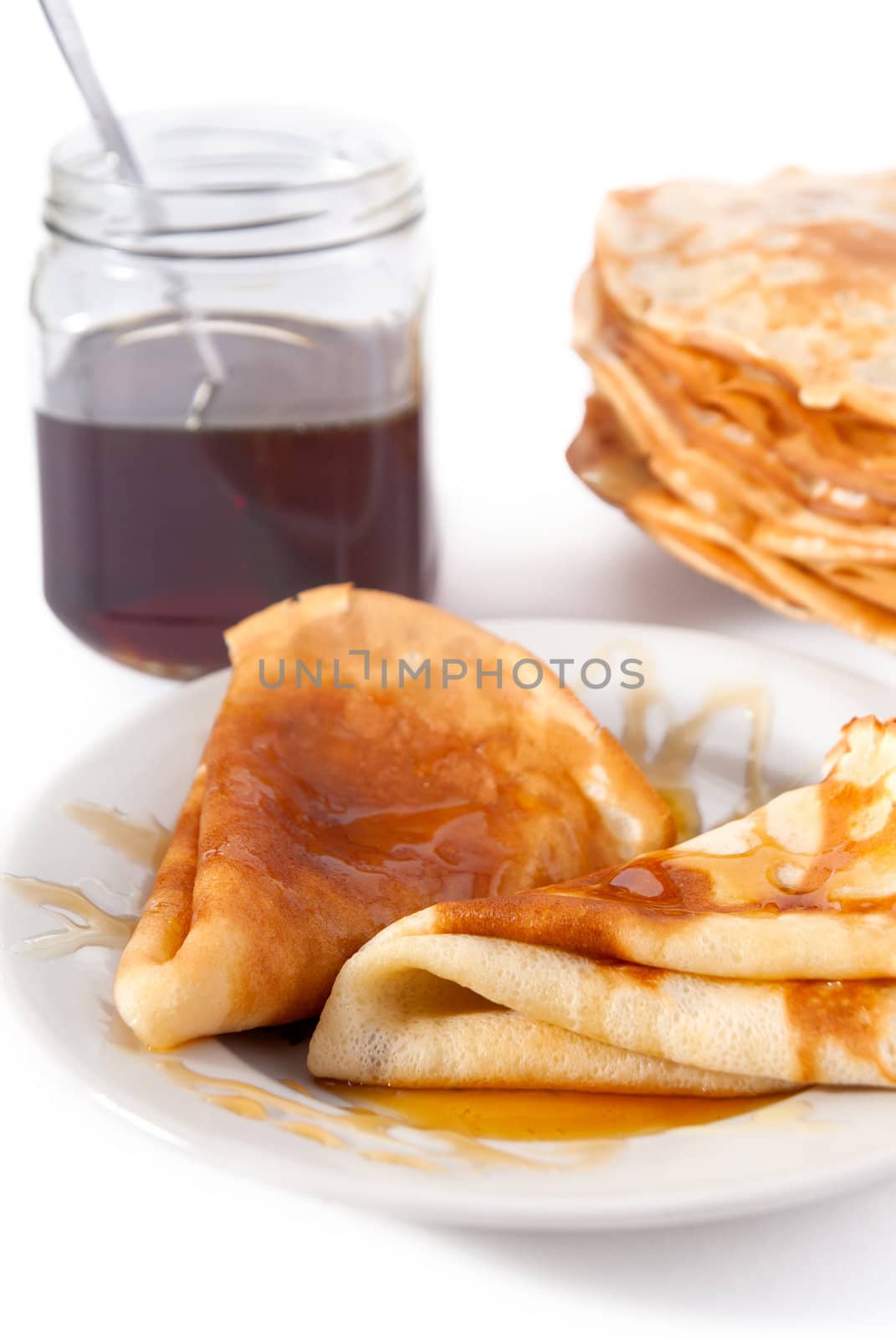 Russian pancake with honey on white