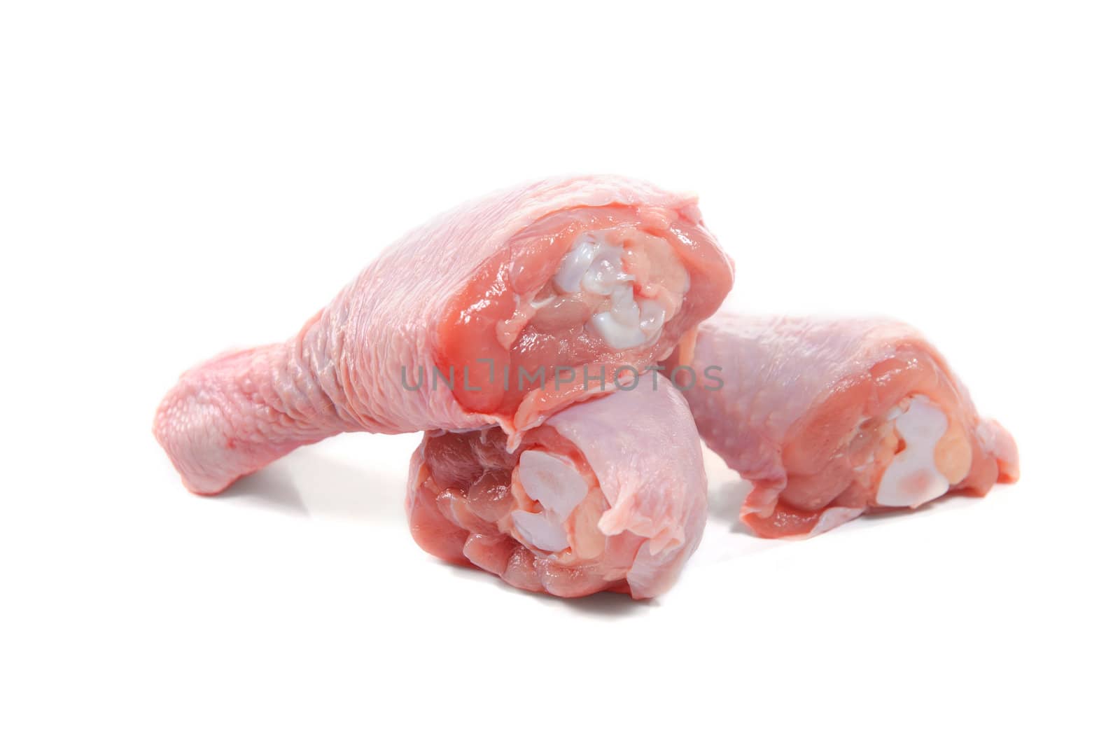 Three fresh raw chicken legs isolated on white background