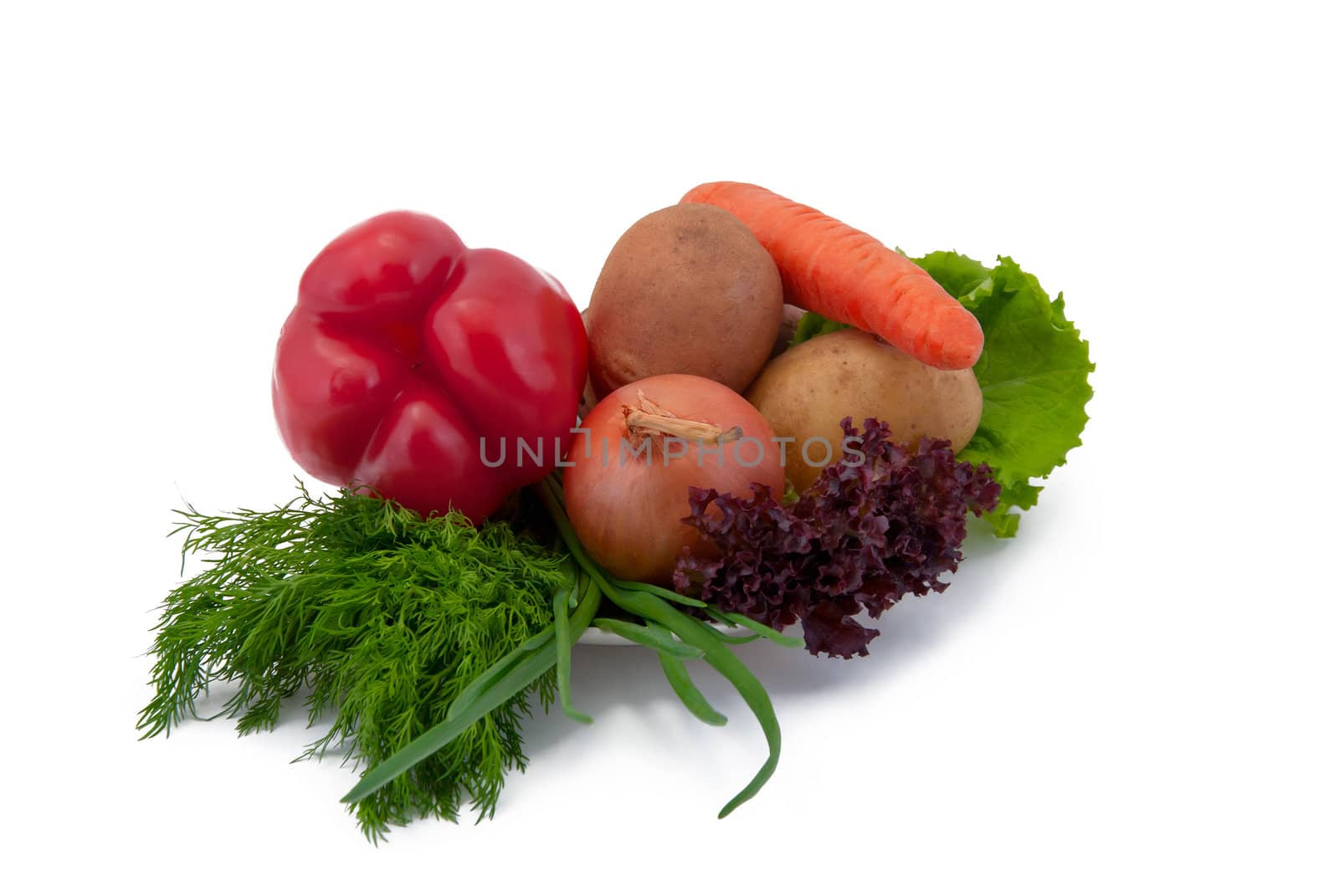 Vegetables on a plate, isolated on white background