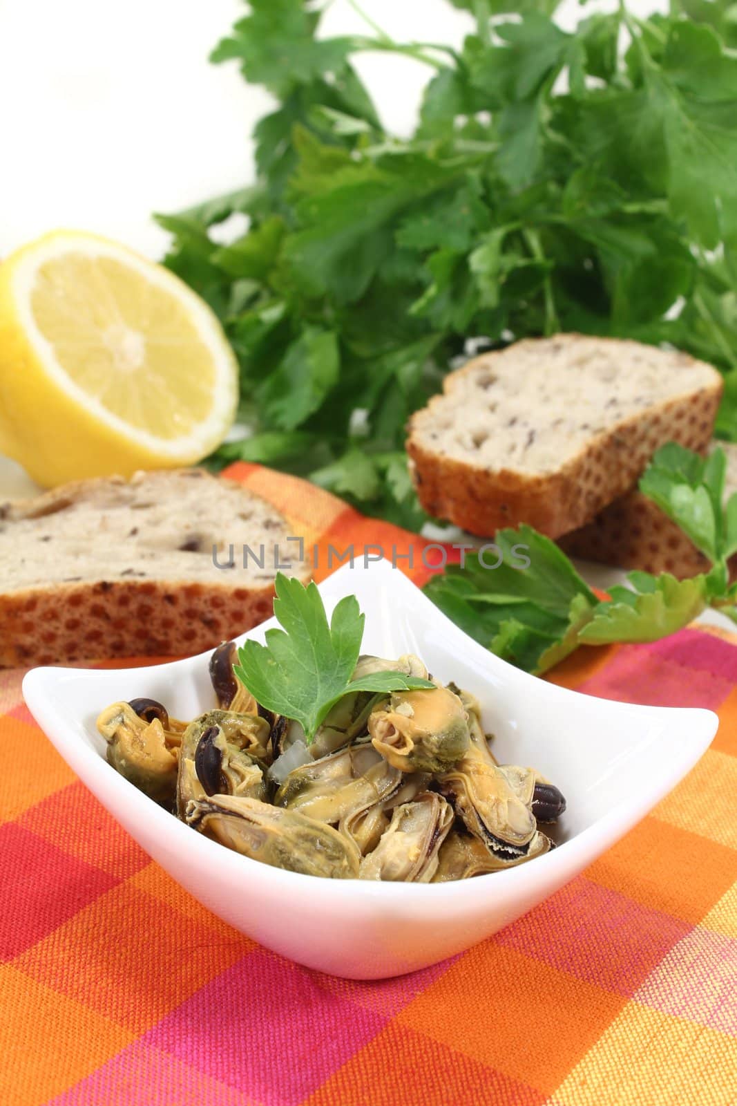 a bowl of marinated mussels and parsley