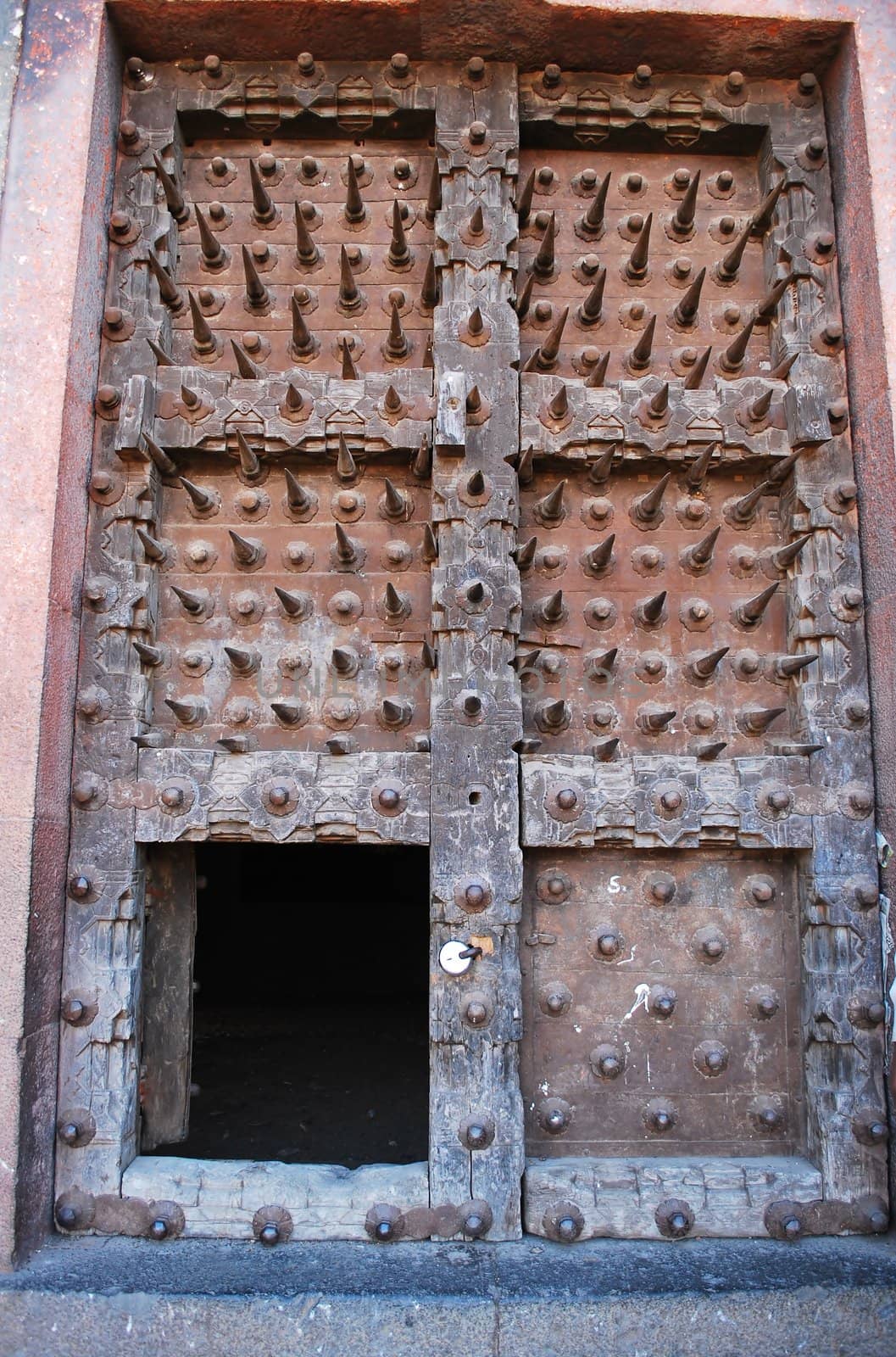 An acient 400 years old fort wooden door with sharp spikes Purandr  poona Mahareashtra India