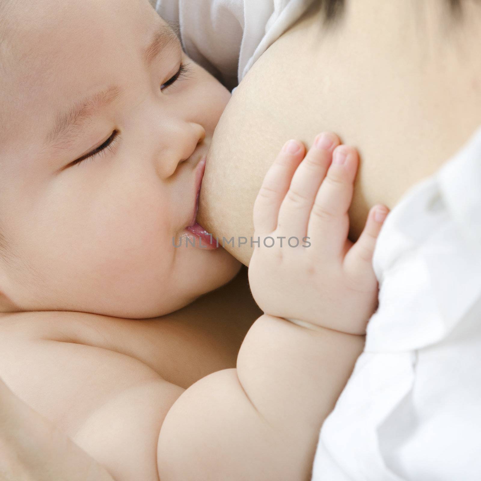 Asian mother breast feeding her infant