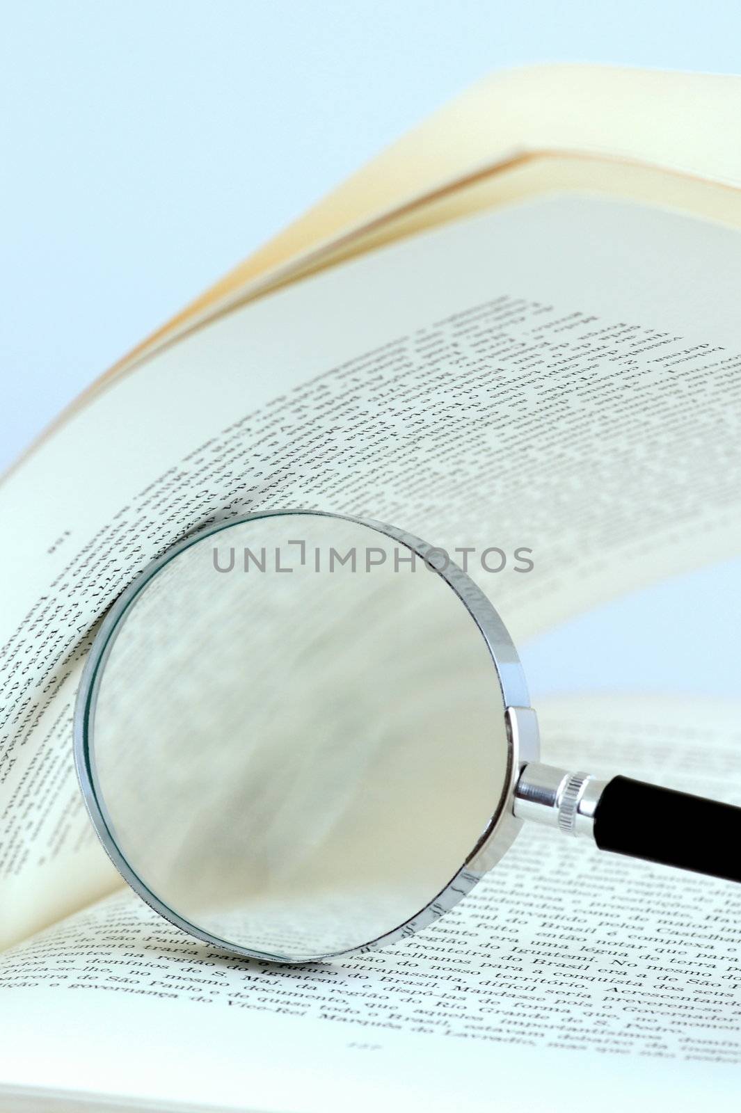 Book and magnifying glass