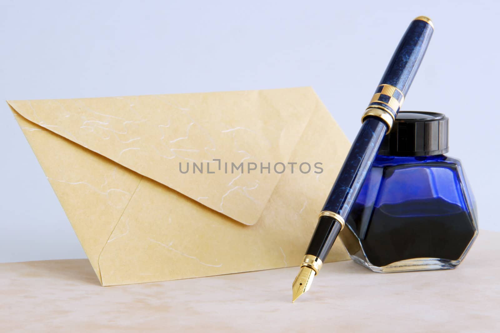 A fountain pen with blue ink and envelope