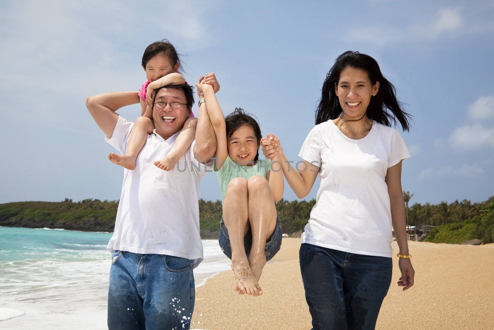 happy family on the beach by tomwang