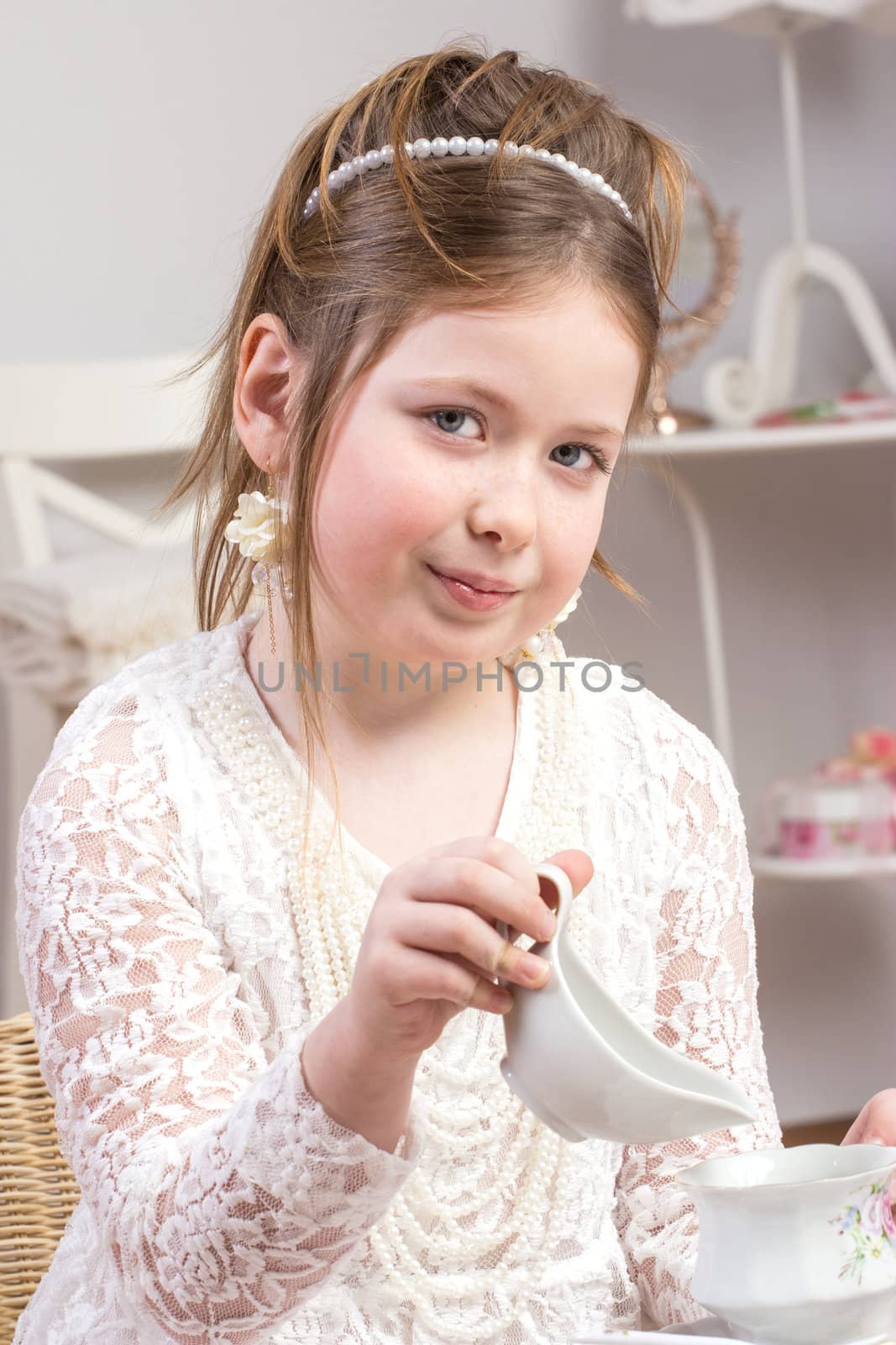 A beautiful little girl having a tea party