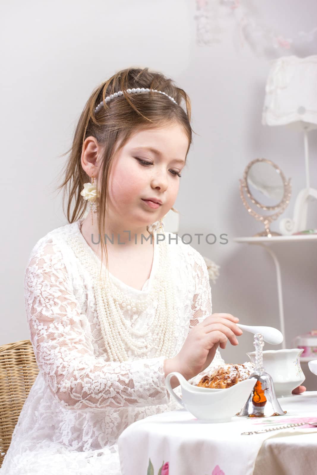 A beautiful little girl having a tea party