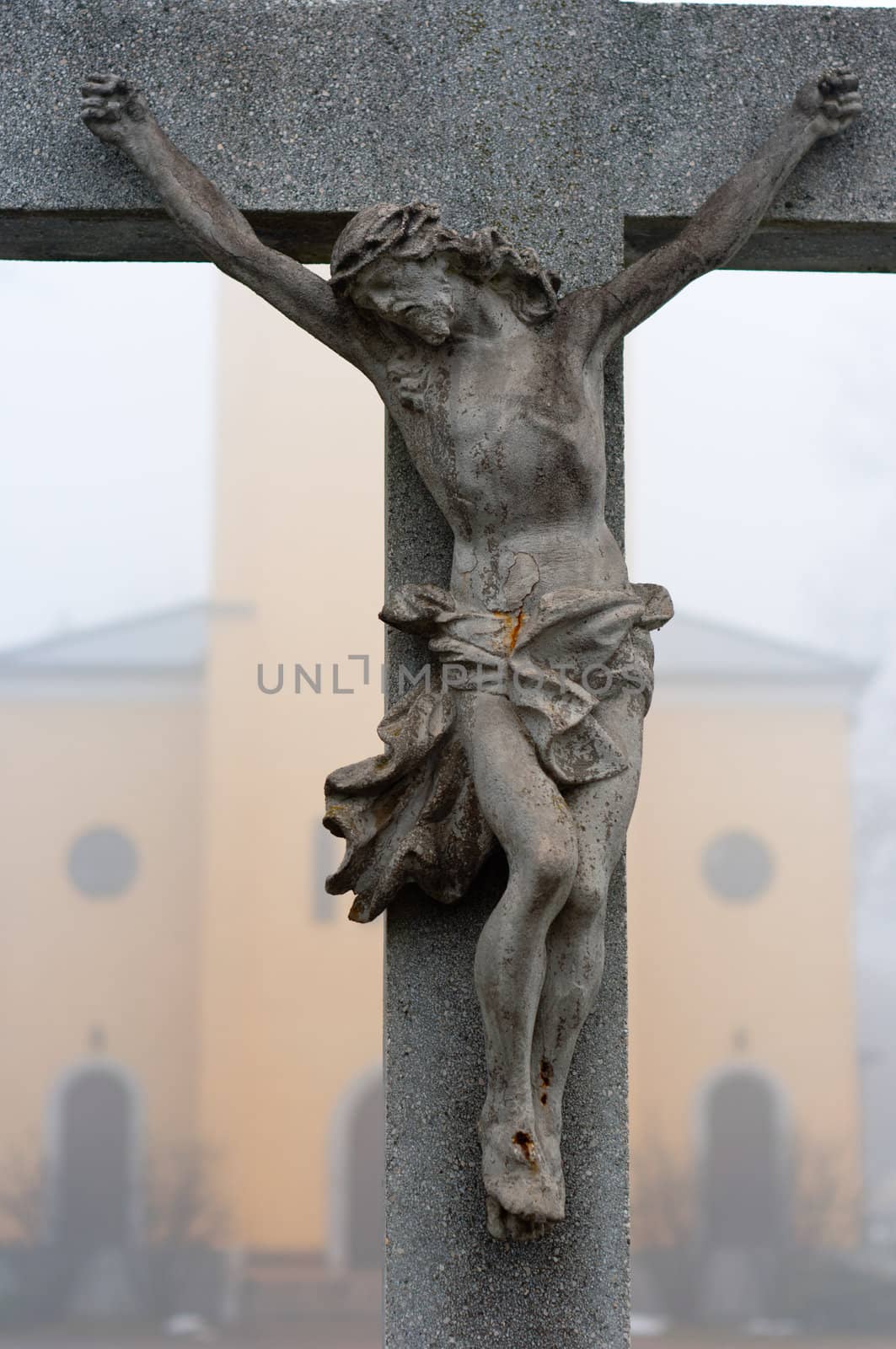 Stone cross with Jesus Christ crucifixion