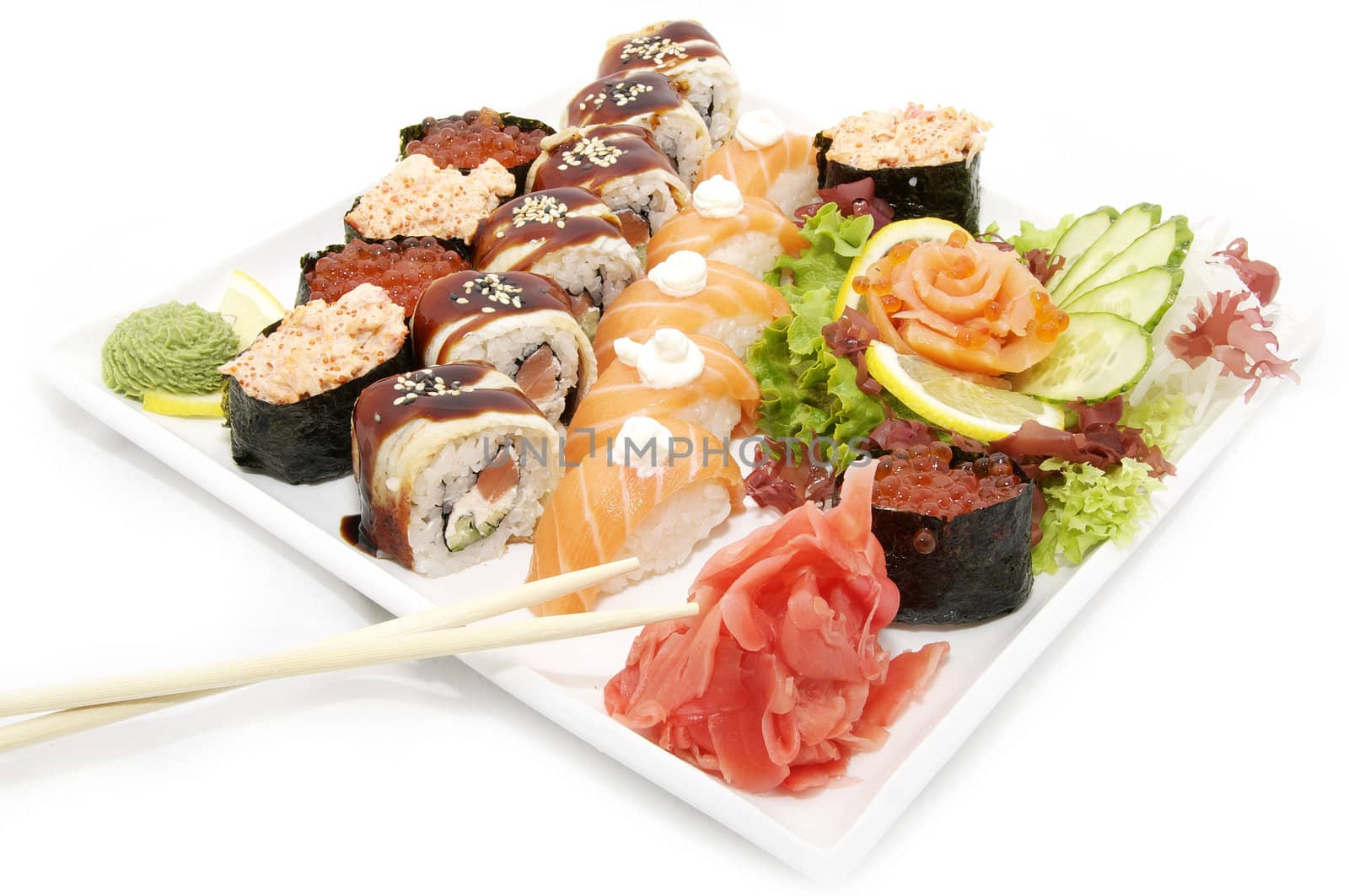 large plate of sushi and cucumber salad decoration