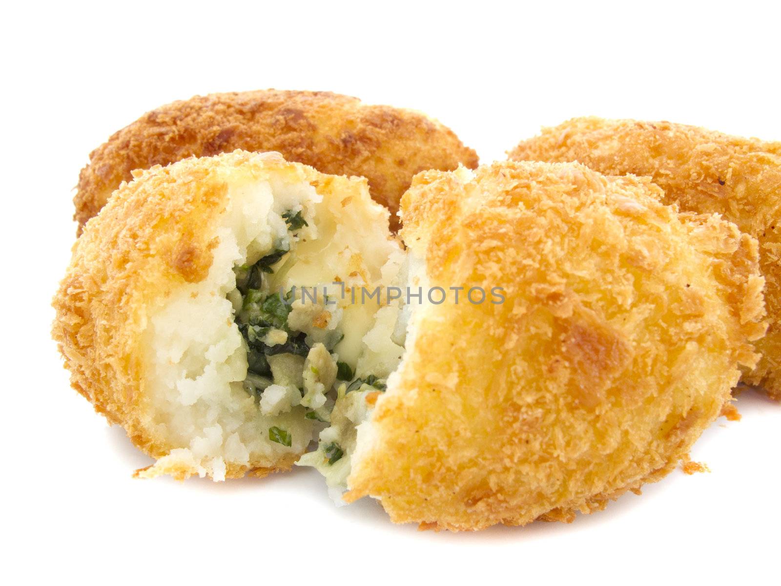 Three croquettes on white background with one is cutting 