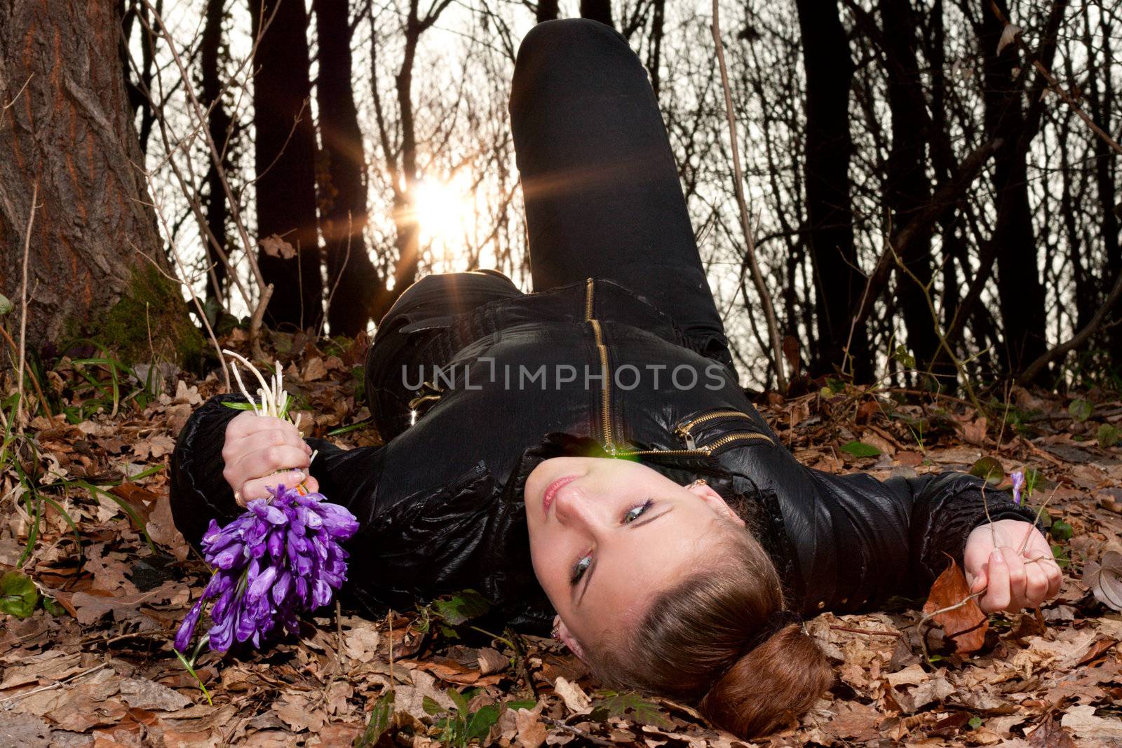 beautiful girl with snowdrops in a forest