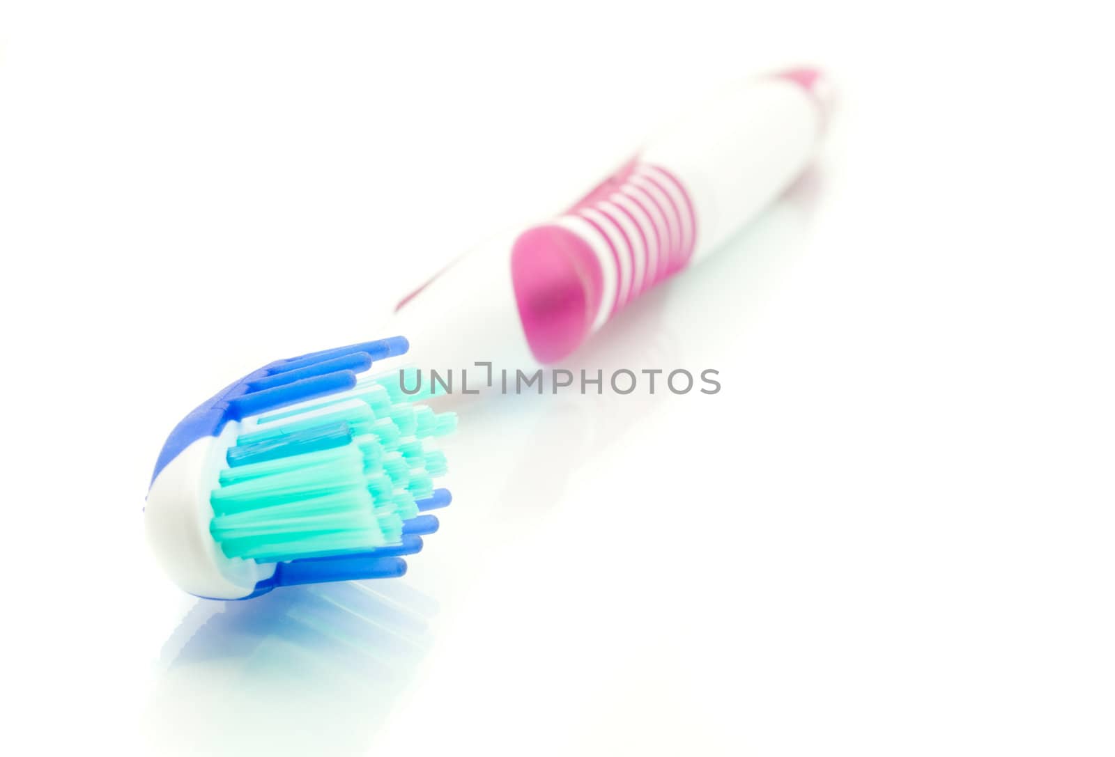 Healthy lifestyle - modern toothbrush on white (focus on bristle)