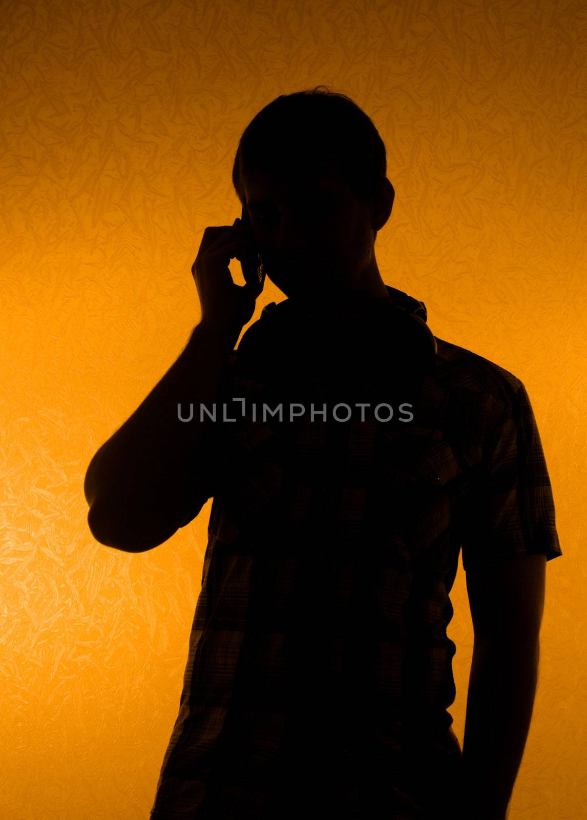 Communication - silhouette of man speak over the phone (back light)