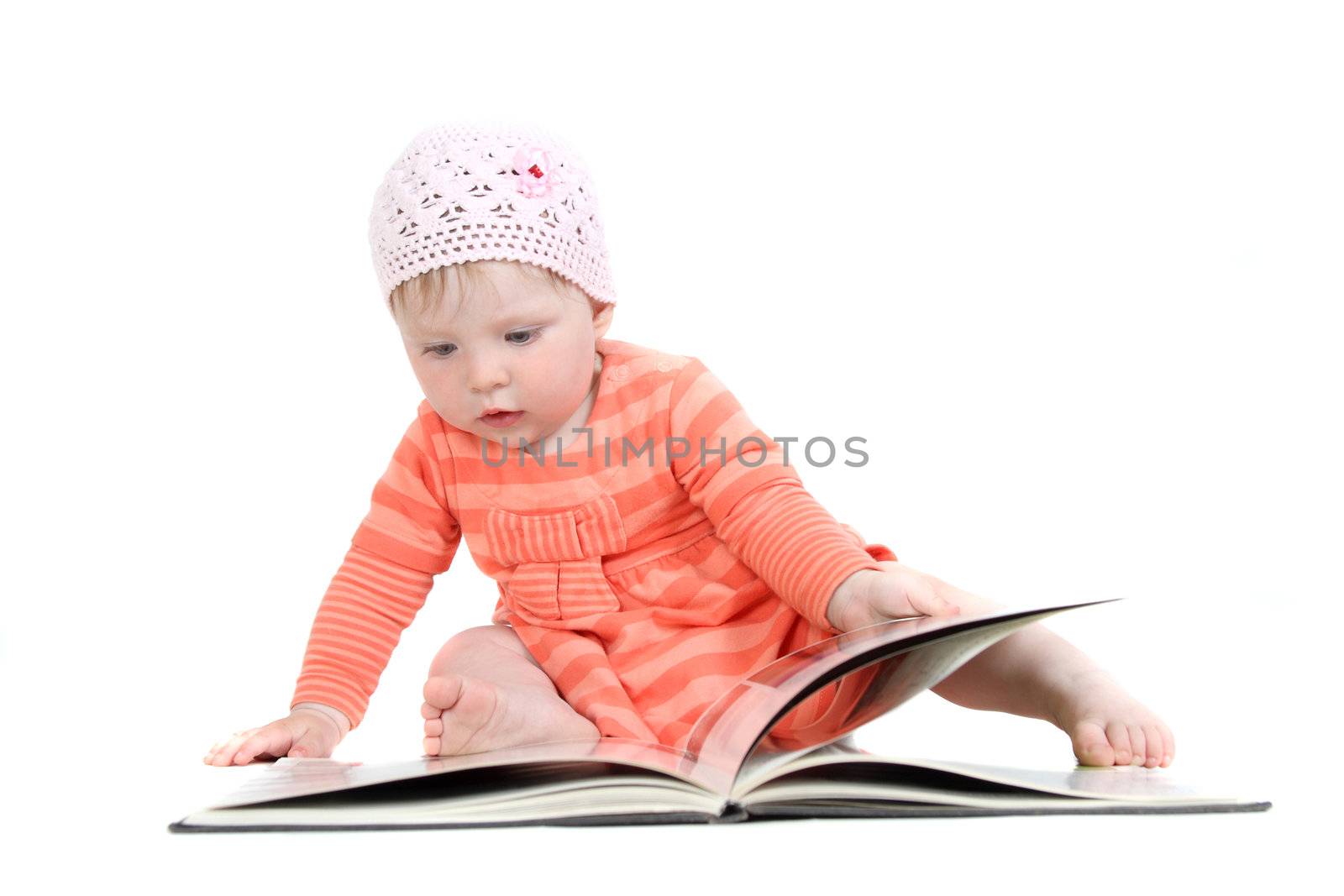 The little blue-eyed girl thumbs through the book. A portrait on a white background. Option 4