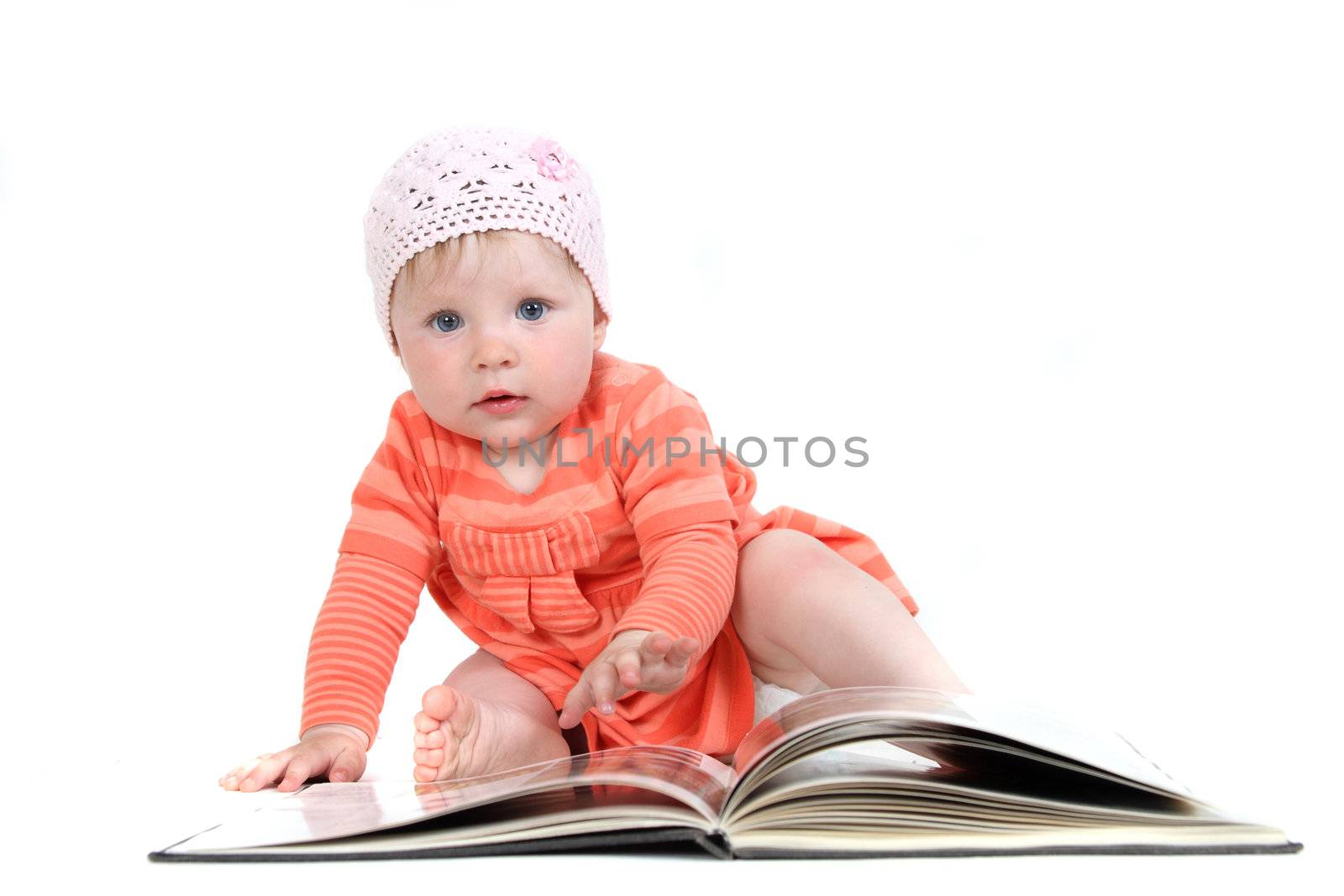 The little blue-eyed girl thumbs through the book. A portrait on a white background. Option 9