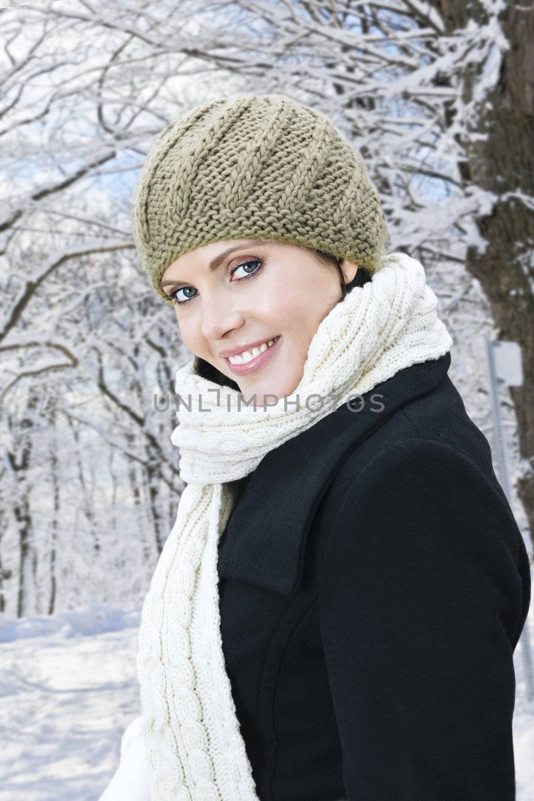 Portrait of young happy woman outdoors in winter