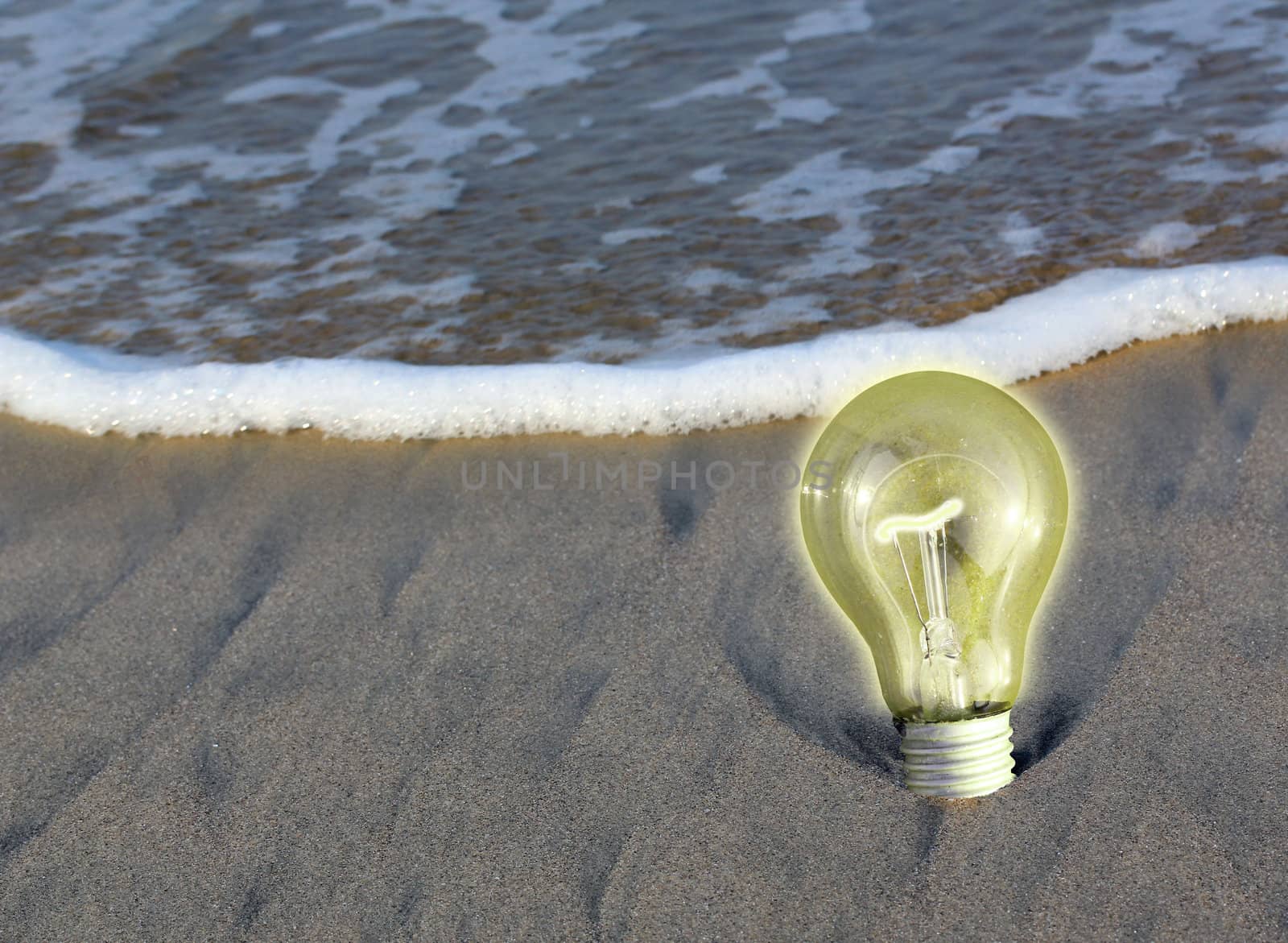 Glowing ight bulb on a beach, concept of determination, persistence, staying put and remaining steady.