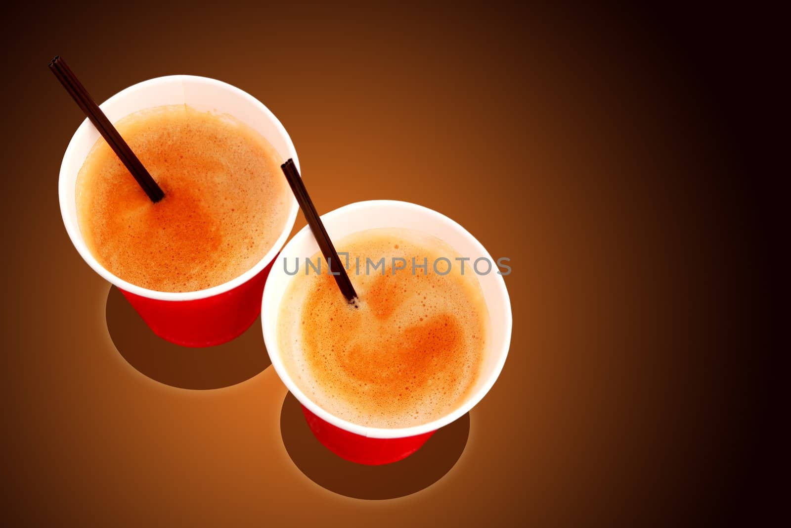 Two paper coffee cups filled with freshly brewed coffee served at a cafe