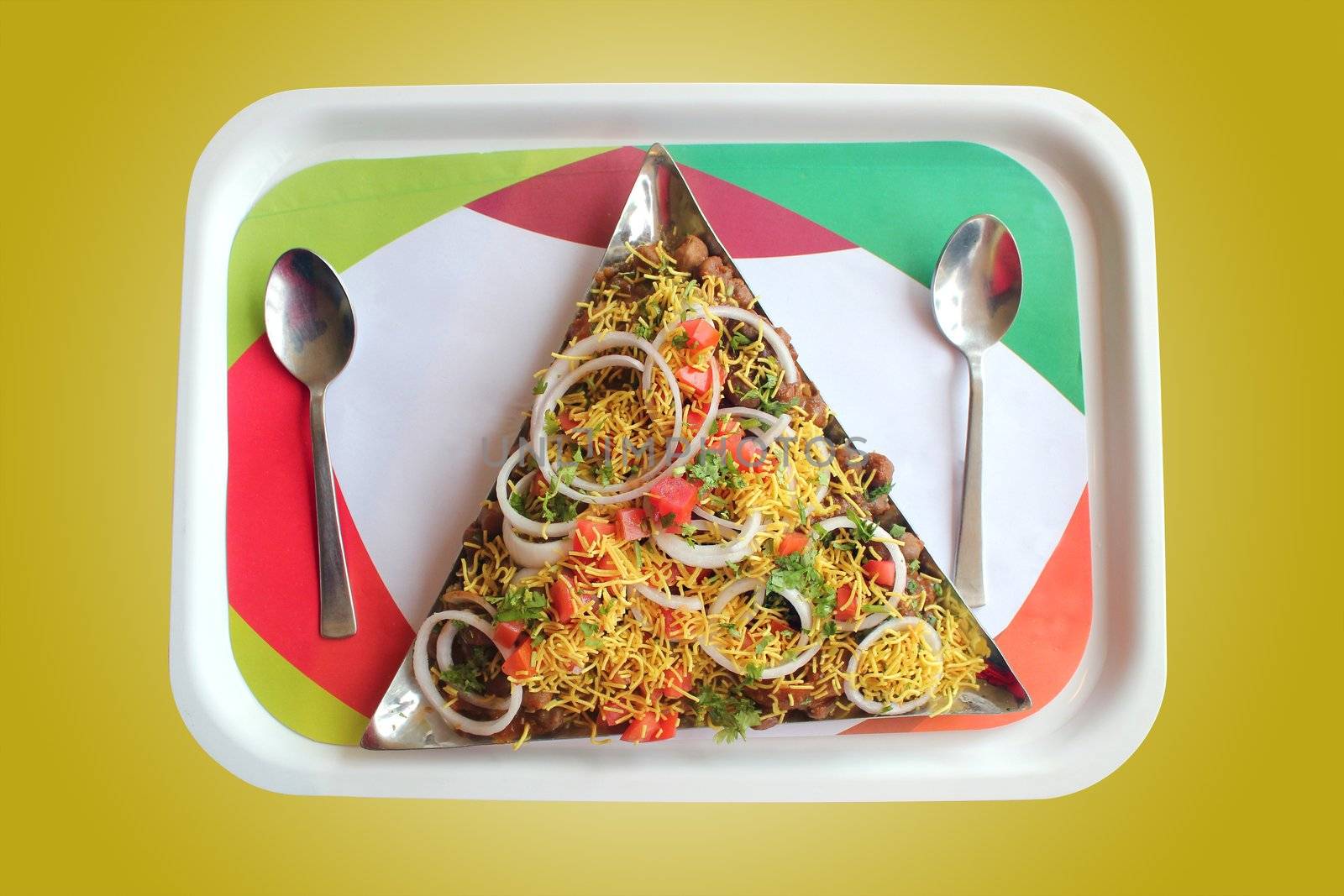 Indian chaat snack called masala puri or sev puri made with tangy sauce, fried bread, vegetables and fruits and sev. Image with clipping mask