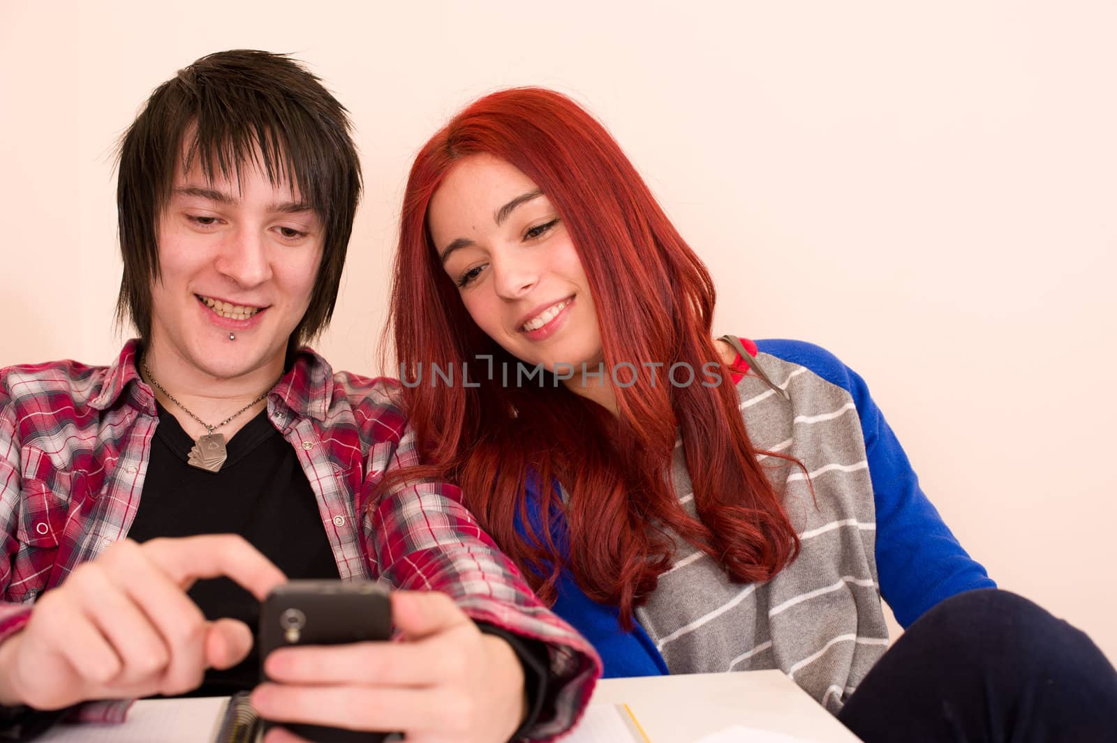 Teens reading some content that makes them smile